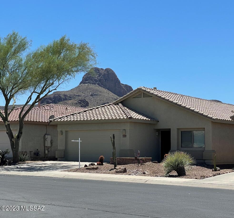 You have found your new home! With great Sombrero Peak views from the rear yard which backs to an open desert area, this home is move in ready, in fact this home is like new! The interior & exterior painting was just completed as well as new carpet. With 1,660 square feet of living space there are three bedrooms & two baths. The owner's suite features a large 14'x20' bedroom, large walk in closet, well appointed bath with a dual sink vanity, separate soaking garden bath & walk-in shower. Other features include a gas fireplace in family room which is off of the kitchen, high 9' ceilings, new upgraded oil rubbed bronze lighting & hardware, ceiling fans throughout, new garage door, epoxy finish garage floor, newer HVAC with 410A coolant and more.