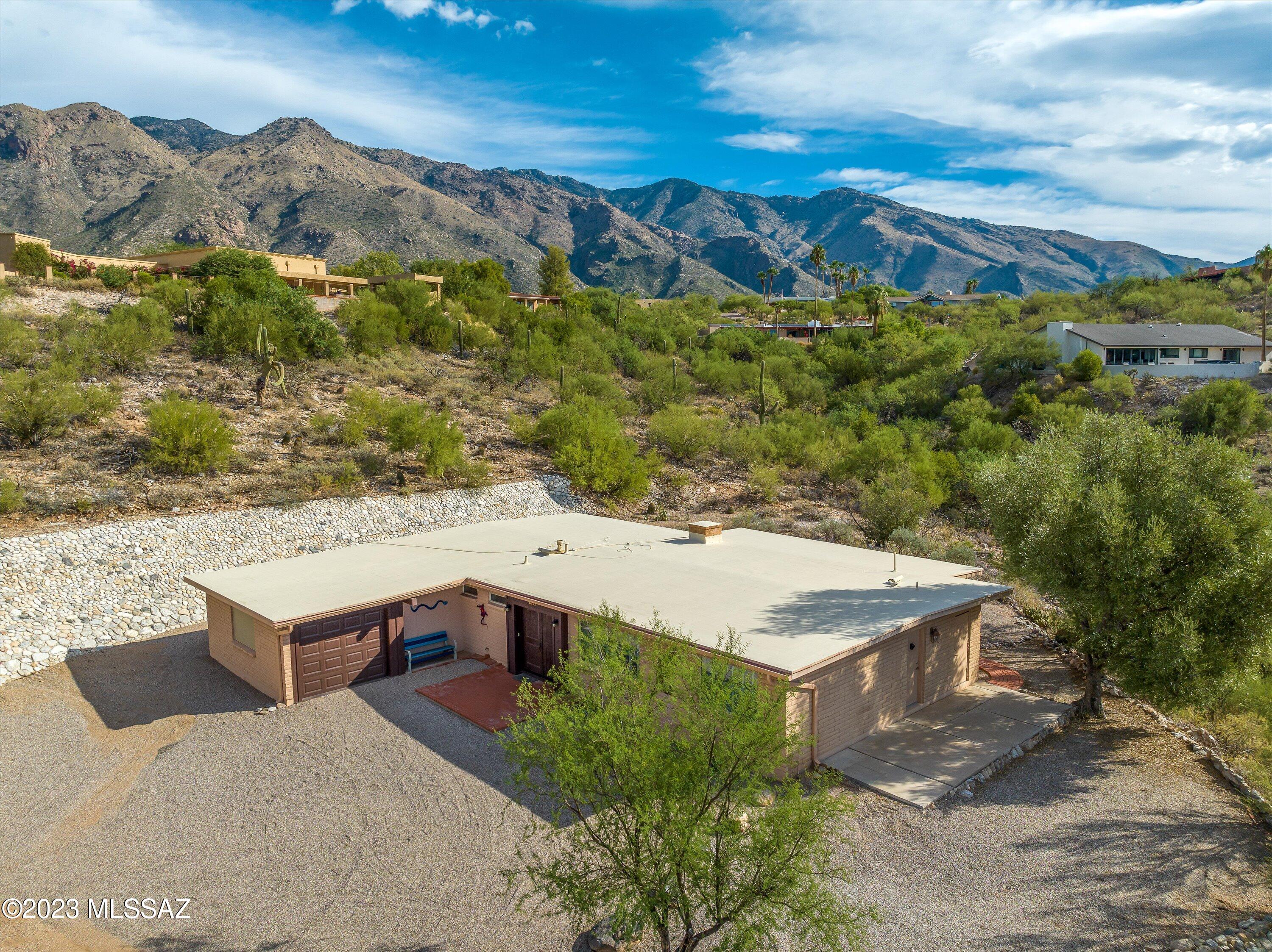Spectacular views of the Catalinas from this birding paradise, on a private peninsula above a seasonal wash! This energy efficient home has been meticulously maintained, with numerous upgrades, including new Pella windows and a new Lennox HVAC. Prime location in Skyline Bel Air Estates, a highly desirable community which offers tennis and a junior olympic pool. Come take a view!