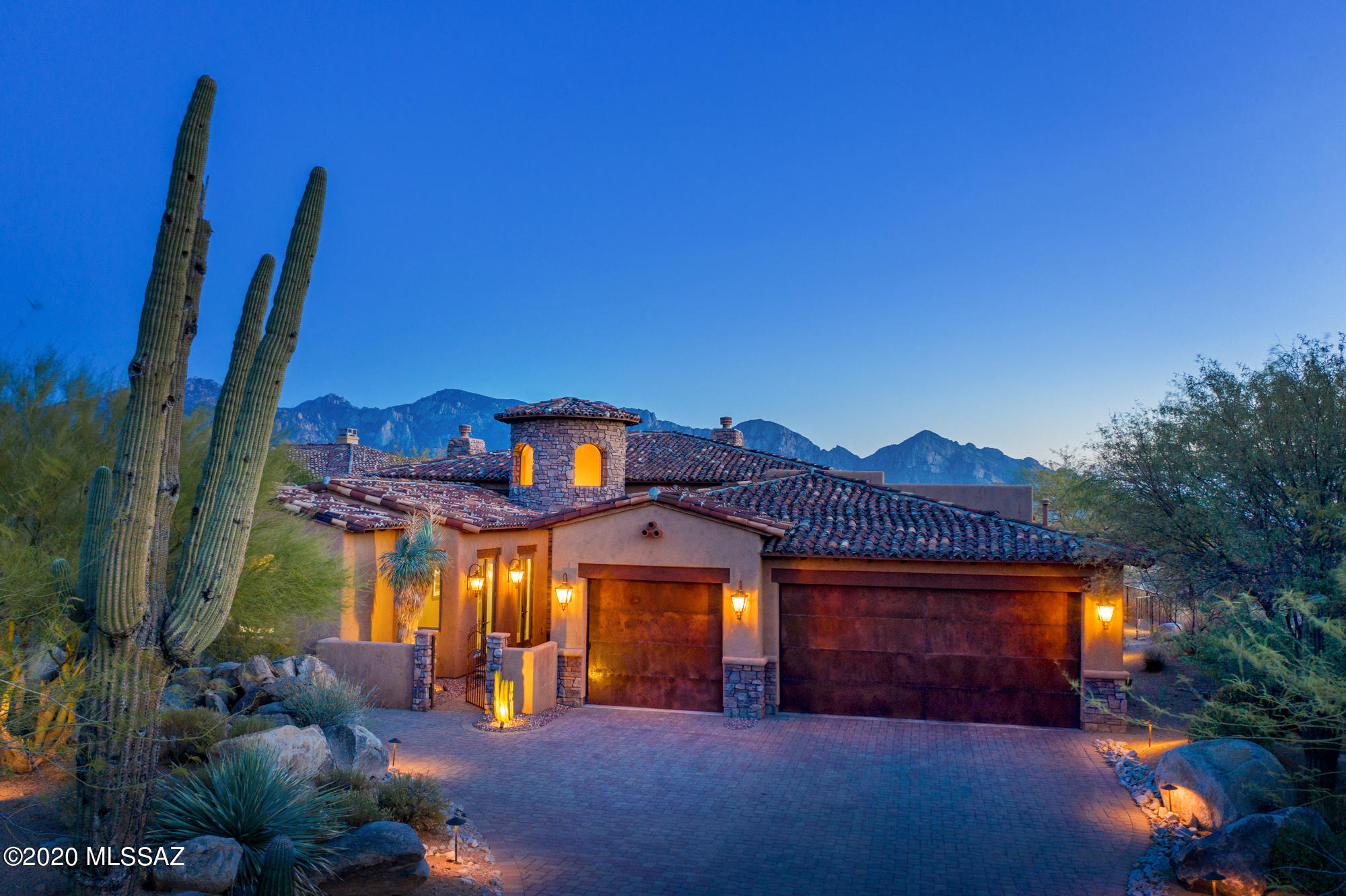 Stone Gate at Stone Canyon - A Guard-Gated Golf Community! Enjoy amazing unobstructed views of mountain peaks, city lights and colorful sunsets from this exclusive residence situated on an elevated .77 acre lot. A small enclave of Tuscan-inspired architecture designed to bring the outdoors in. The exquisite home features a gated courtyard, natural boulders and majestic saguaros, and an abundance of windows,  making the scenery around it the star of the show. Upon entering the 3,082 sqft luxury residence, you'll be enveloped in natural light from the floor-to-ceiling windows with panoramic views, wood beams, travertine floors, den, formal dining and living rooms with fireplaces, and a great room with raised fireplace that adjoins the spacious kitchen. The kitchen color palette is rich looking, modern with Stainless steel appliances, cherry wood cabinets with under-cabinets lights and accent lights to highlight black granite countertops and backsplash. The island lends itself perfectly to hosting large gatherings. All bedrooms include ensuite baths. The master wing is separate from the other two bedrooms and features a hallway with two French doors leading to gated courtyard. The privacy of the Master wing is sure to please, with walk in closet, expansive shower, and double vanities. The house perfectly frames the views from entire back yard of residence,  two verandas to relax and entertain near the fire pit, cook outdoors from custom grill,  with view fence, professional landscape. Oversized 3 car-garage with rustic metal doors. Call today to schedule a tour of the home and Phil Mickelson's Private Stone Canyon Golf Club: featuring world class golf & fitness facilities, brand new Clubhouse, and restaurant/bar. A Simply Remarkable location!