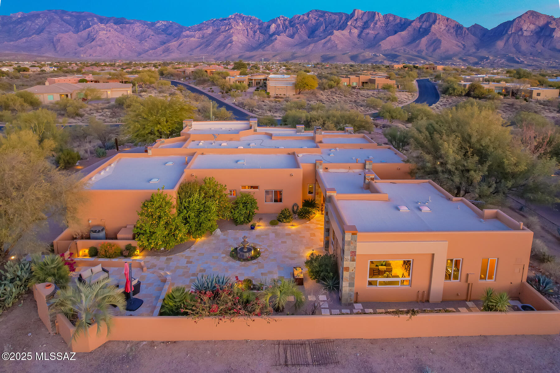 Spectacular CUSTOM LUXURY HOME with Casita plus heated pool & spa resides on a 1.27 acre elevated lot with East/West exposure offering sweeping mountain, sunset and city light views. Gorgeous 3,072sf main home offers 4 bedrooms + 3 full baths (4th bedroom features office built-ins). Private 795sf casita added in 2021 boasts dual patio doors, open concept living/dining area, Thomasville cabinets, full gourmet kitchen hosting island with bar and granite/stainless amenities, plus a luxury bath with tiled shower. Main home features formal living room with floor-to-ceiling slate tiled fireplace, dining or family room with large picture windows, dining nook with hexagon shaped view windows, plus sleek updated kitchen with custom cherrywood cabinets, suede quartz countertops, center island, Sub-Zero fridge/freezer plus gas cooktop and in-wall ovens. Owner's suite hosts a floor-to-ceiling slate tiled media wall with fireplace plus updated spa-like bath with jetted tub, large walk-in shower and custom closet. Guest wing hosts 2 split bedrooms with central bath. Study/Bedroom 4 offers custom Knotty Alder cabinets with file drawers, computer drawer, and upper built-in shelves with crown molding. This magnificent home also boasts a gated front courtyard with fountain, East facing patio with heated Pebble-tec pool, raised spa patio, BBQ island and granite bar island, reimagined yard extension with decorative turf and fire-water feature, plus uncompromising forever views. Expansive West facing patio offers a central tiered fountain, raised fireplace patio and private casita entrance. Additional laundry room with sink and barn door entry, 3-car extended garage with storage cabinets and workbench, multiple skylights, security system and whole house water filtration. Luxury and architectural updates throughout including Travertine tiled floors in most rooms, slate tiled columns inside & out, plus Travertine tiled patios and courtyard. Lush landscaping abounds including desert plantings, flowering shrubs and multiple fruit and citrus trees. Perfect for the most discerning buyer!