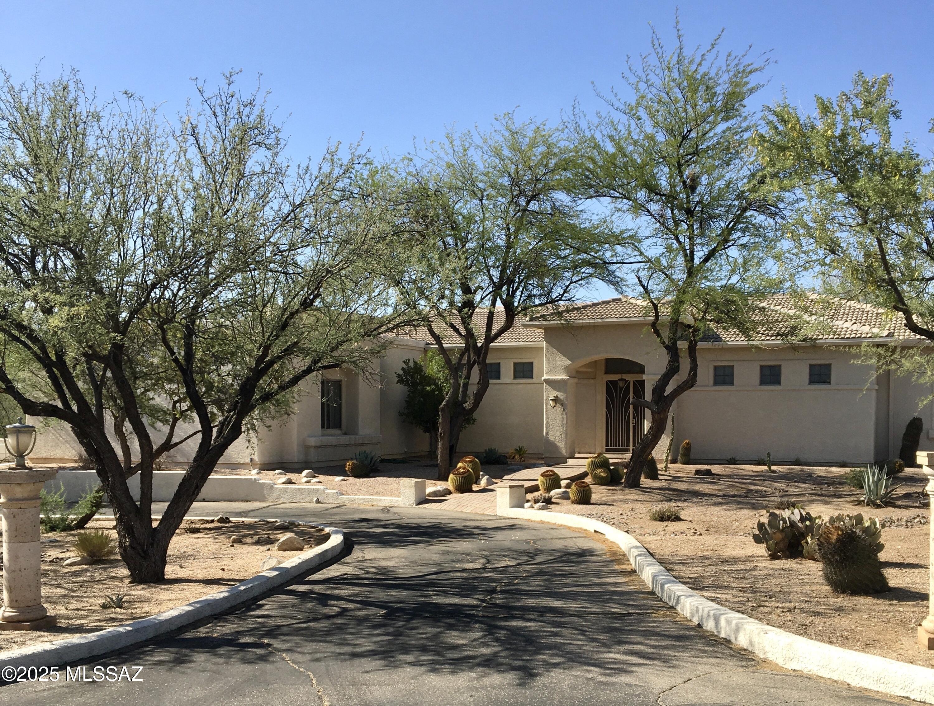 Beautiful one owner custom built home with registered private well on 4 acres of horse property!Dead end street backs up to LaMariposa Resort and some of the best riding trails in Tucson.
Foyer opens up to great room with mountain views &huge back porch complete with outdoor kitchen and ceiling fans,great for entertaining! Split bdrm plan with access to back porch from master suite. Master has well thought out very large walk in closet,& beautiful master bath with dual shower.
Custom kitchen with pull outs in pantry and most cabinets, prep sink, and little roll top desk. There is a very nice size laundry room with sink and plenty of cabinets that opens up to spacious 3 car garage with built in workshop, cabinets, &extra storage. 
This is a rare chance to own in this 4 home enclave!!