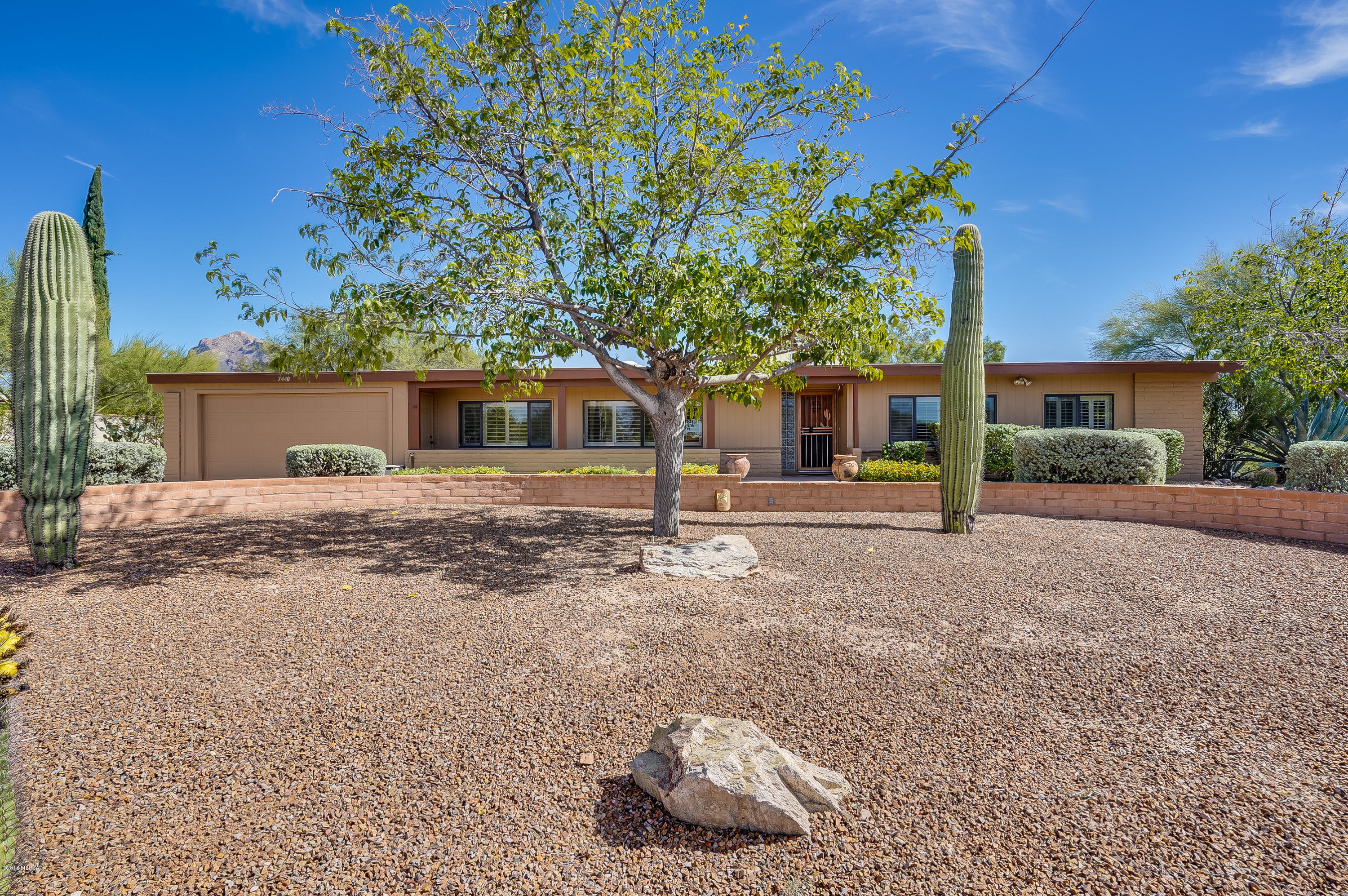 Great opportunity to own a beautifully updated 4 bedroom 2 bath home in Casas Adobes. No shortage of living space here with a formal dining room featuring oak hard wood flooring, living room and great room off the kitchen. Great room features a wood burning beehive fireplace. New Shaker Style kitchen cabinets, granite counters, custom back splash, stainless steel appliances, Master suite features a private retreat area with private backyard entrance, double closets, 3 additional bedrooms are generous in  size. Large laundry room with overflow pantry storage. Attached 2 car garage, Pavered circular driveway ushers you into this private mountain view lot featuring a pool, built in outdoor kitchen, beehive fireplace, basketball court, Covered RV parking/carport..