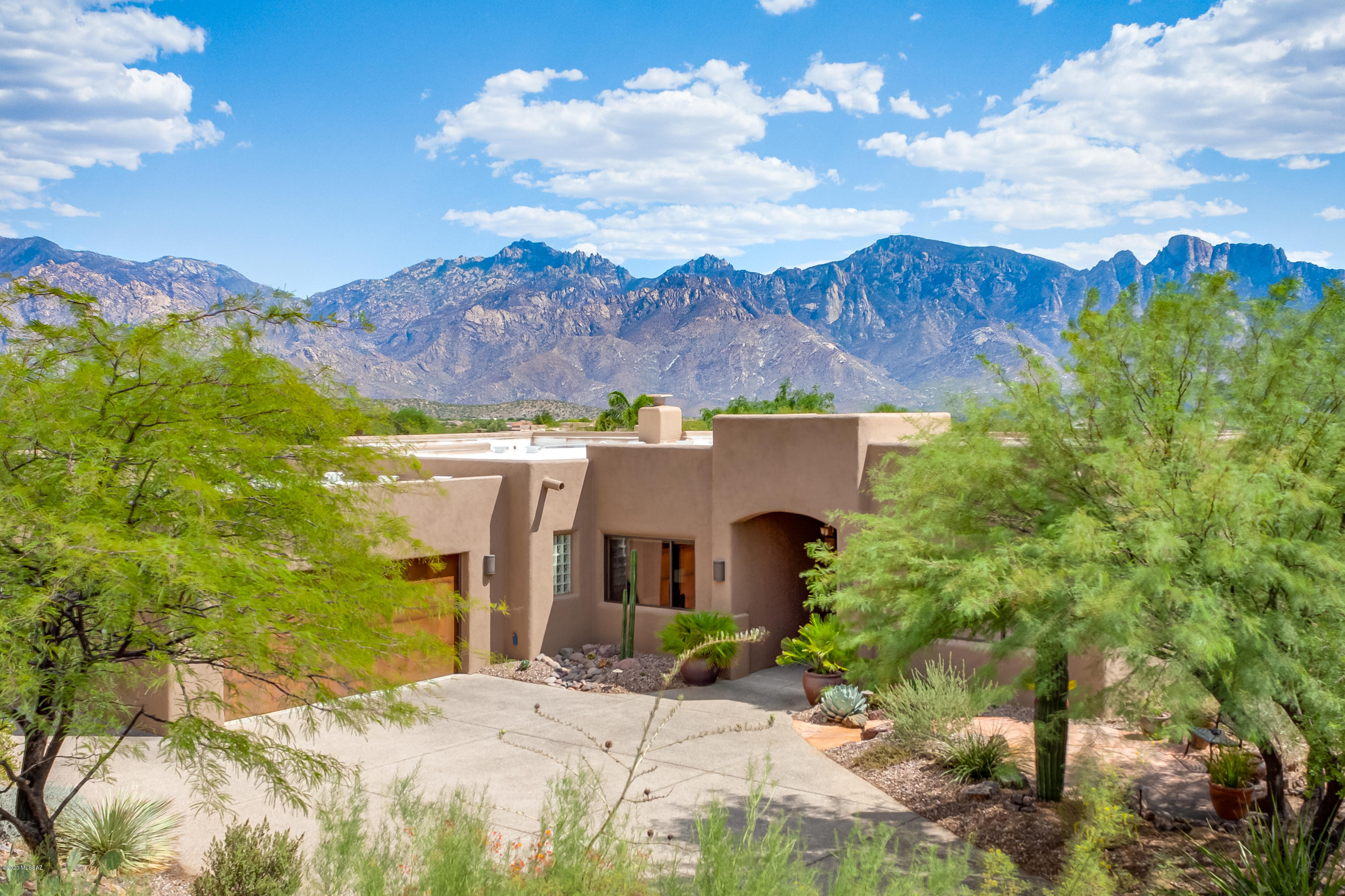 Everything you could want is here in this single-story soft contemporary 3,052sf 3BR/3BA+den/office on East-facing premium lot w/unobstructed Catalina Mountain Views from inside & out in gated Estates at High Mesa in Oro Valley. Open concept & oversized windows invite great views of the beautifully landscaped backyard, pool, spa, desert & Catalina Mountain views beyond. Gourmet Kitchen features cherry wood cabinets, Viking stainless appliances, Gas Cooktop, Granite counters & casual dining area. Family room has fireplace open to formal dining & living area. Tongue & Groove wood ceilings add textural contrast to walls & travertine flooring found throughout most of the home. Spacious Master Suite has ceramic tile plank flooring, jetted tub, separate shower, huge walk-in closet. 3-car garage.