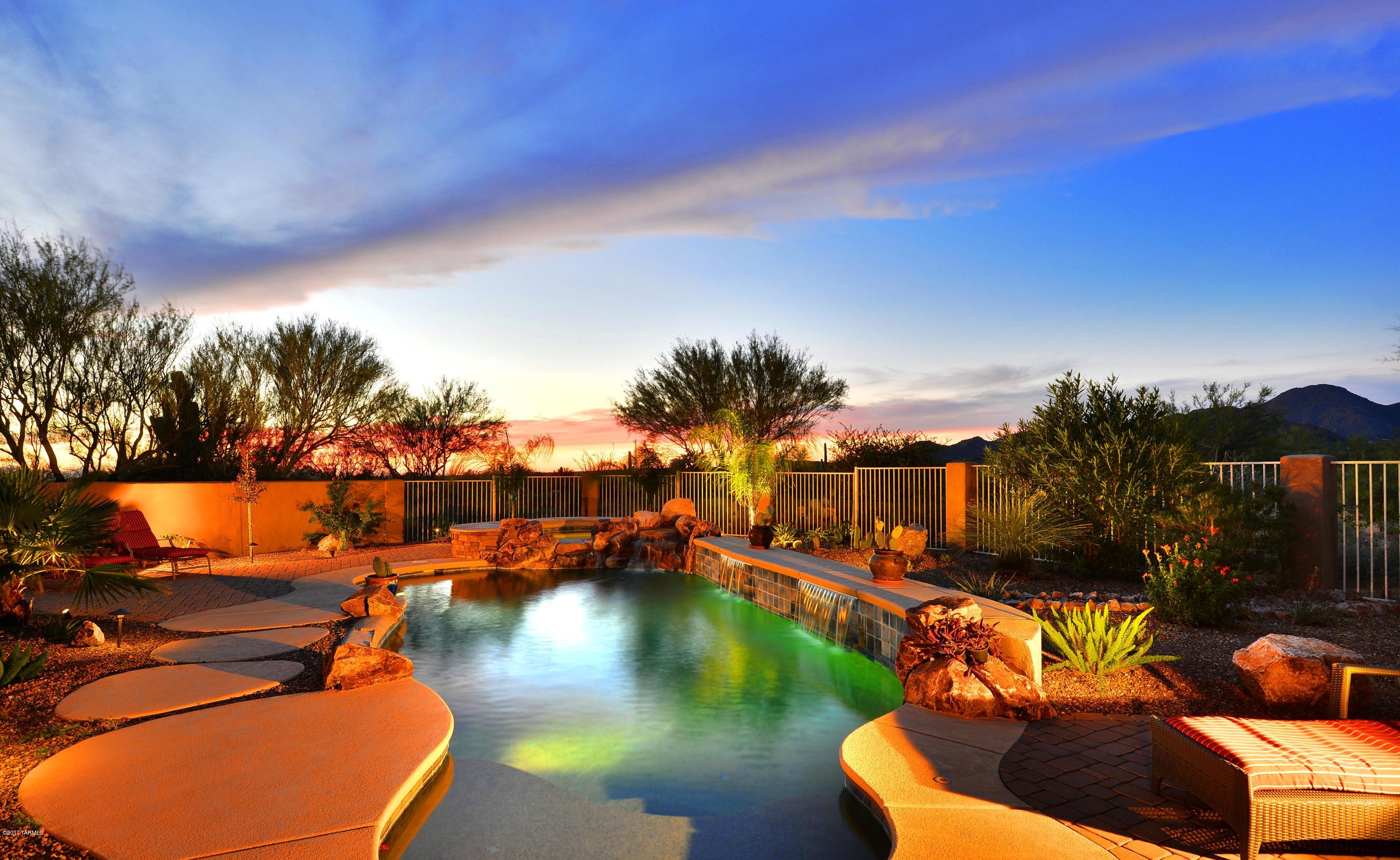 Private retreat in the Sonoran desert at the base of the Tortolita Mountains. Located in the gated Butterfly Mountain with mountain & desert views.
4234 sq ft of living space includes the attached casita with separate entrance off patio.  Your guest will love the privacy of the casita with it’s own bath and double door entry – or you could use the casita for additional backyard entertaining/game room, etc.  This exquisite home boasts 4 guest in-suite bdrms plus the master suite. A sampling of the many features of this home include tumbled travertine floors, 3 fireplaces, gourmet kitchen with stainless steel built in appliances, multiple patio areas (front & back), outdoor kitchen, pebble-tec pool & spa and so much more! See Amenities list attached.
Located close to Dove Mtn, golf cou Seller is offering a gift certificate to Buyer -- see document attached.