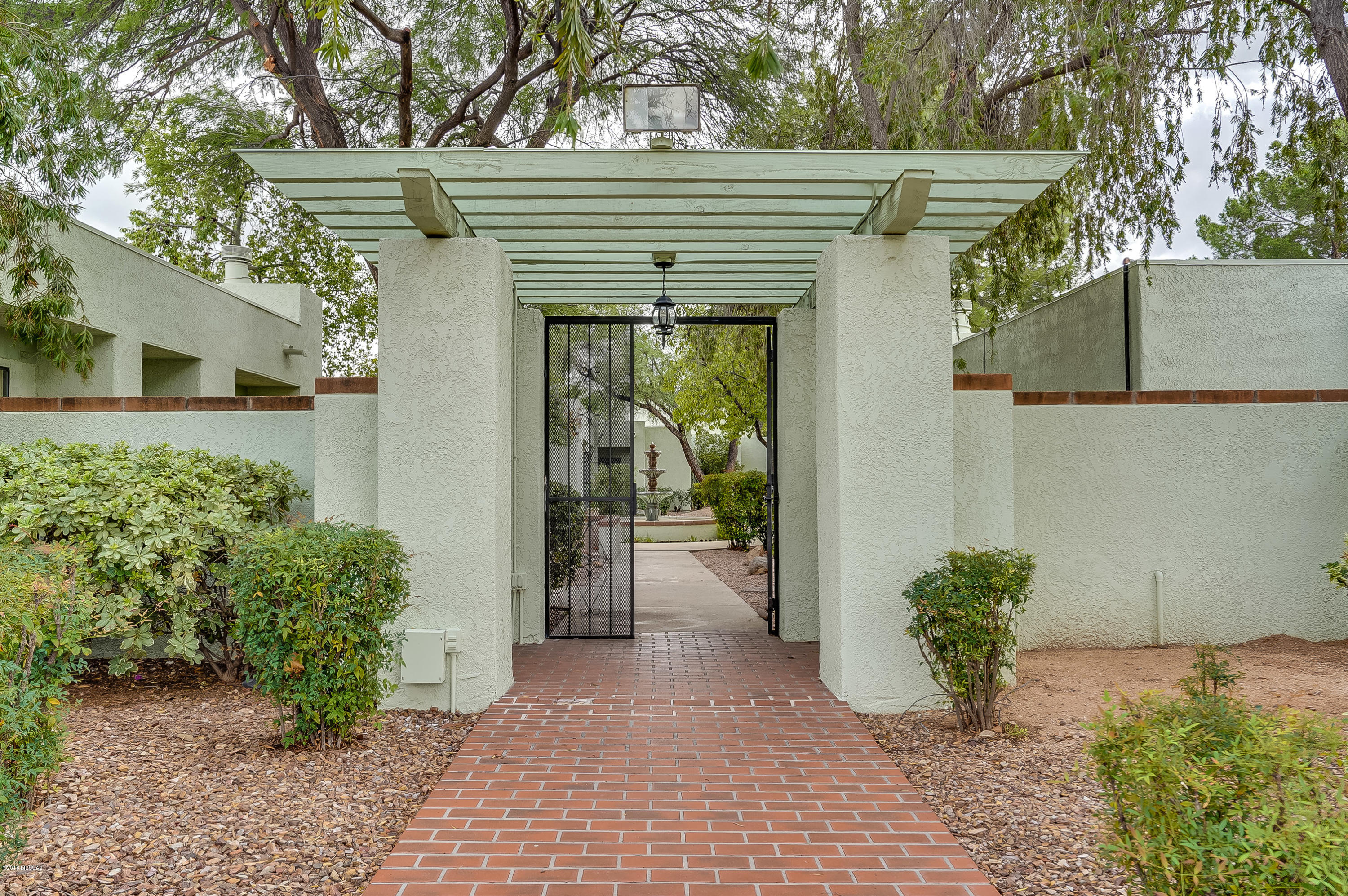 FABULOUS TOWN HOME IN GATED, RARELY FOR SALE COMMUNITY Of ONLY 28 Units.  AWESOME LOCATION! This 2 Bedroom 2 Bath Plus Den/Office Has A Beautifully REMODELED KITCHEN w/Bosch Stainless Steel Appliances. Quartz Countertops, Tiled Backsplash w/Lots Of Cabinets, Coffee/Laptop Station, Dining Area PLUS Bar Seating.   Skylights in Kitchen. Large Neutral Tile Throughout.  Bedroom Has New Sliders That Open Up To A Quaint Backyard w/Relaxing Sounds From One Of Many Community Fountains. HVAC Is Only 5 Years Old, Interior Painted 2 Years Ago. Roof Recently Recoated, Exterior Of All Units Painted Last Year! HUGE Swimming Pool and Spa To Relax & Wind Down.  PERFECT Winter Get Away Or Full Time Living!   Large Two Car Garage w/Cabinets!  MUST SEE!!