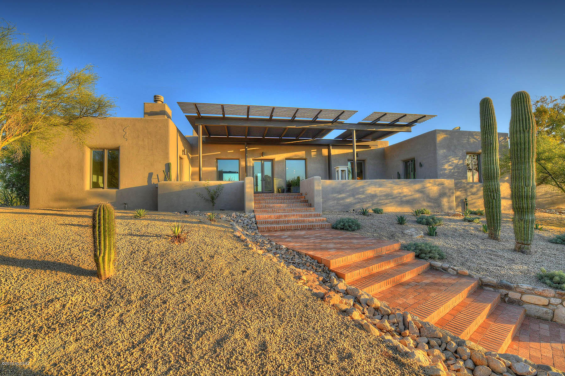 The Ultimate Blend Of Authentic Adobe Construction & Modern Function + Style  In This Completely Remodeled Masterpiece in Guard Gated Catalina Foothills Estates #10. Located High on a Ridge, The Open Floor Plan Of This Home Captures Explosive Mountain & City Views From Every Room.  Some of The Fine Features Include: Poured Concrete Floors, Marvin Windows & Doors, Wood Beamed Ceilings, Island Kitchen w/Quartz Counters + Wolf & Sub-Zero Appliances All Open to Great Room/Dining Area. Exquisite Tile Work In Kitchen & Baths From Waterworks of Scottsdale, AZ. Enhanced Sound w/SpeakerCraft Speakers. Master Suite Complete w/ Fireplace, Massive Walk In Wardrobe, & Haven Like Bath w/ Dual Sinks, Water Closet, Walk In Shower, & Free Standing Soaker Tub. Other Features Include Two Guest En Suites, Office/Library w/ Fire Place, Brick Paver Circular Drive Entry, Tankless Water Heater. Spacious Rear Grounds w/ Synthetic Grass, Covered Patio, Fireplace & Sumptuous Salt Water Pool w/ Jetliner City Views.  Ideal Proximity to Central Foothills Shopping & Dining, As Well As The UofA & Downtown Tucson. A Simple Yet Elegant Residence With Subtle Indulgences Throughout.