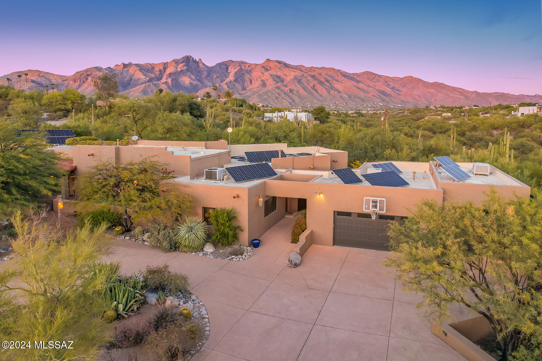 Stunning central foothills home, reminiscent of a Joesler. Beautifully remodeled but retaining that special ''something'' w/high beamed ceilings, detailed woodwork, intricately carved front door. Saltillo in main portions of home, lots of windows and light, view and complete privacy on your end of the road 2.57 acres. Kitch w/Viking gas range, sub zero Refrig & separate Refrig drawers for those ''extra'' items, large walk in pantry. Roll down sun screens on greatroom   west facing windows. Separate guest quarters, 3/4 bath and extra studio space & garage. This area could be made into a much larger guest house w/garage if desired. 12 kw Solar w/20 kw battery storage. Paid for Solar w/$16 a month bill. Room marked on floorplan as FR now being used as office, could be 6th bedroom w/own bath Primary bdrm has two large walk-in closets and stunning bath. Private rear yard w/salt water pool w/rolling cover. Large covered patio areas surrounded by privacy. This could be your own slice of Tucson perfection. Welcome Home!