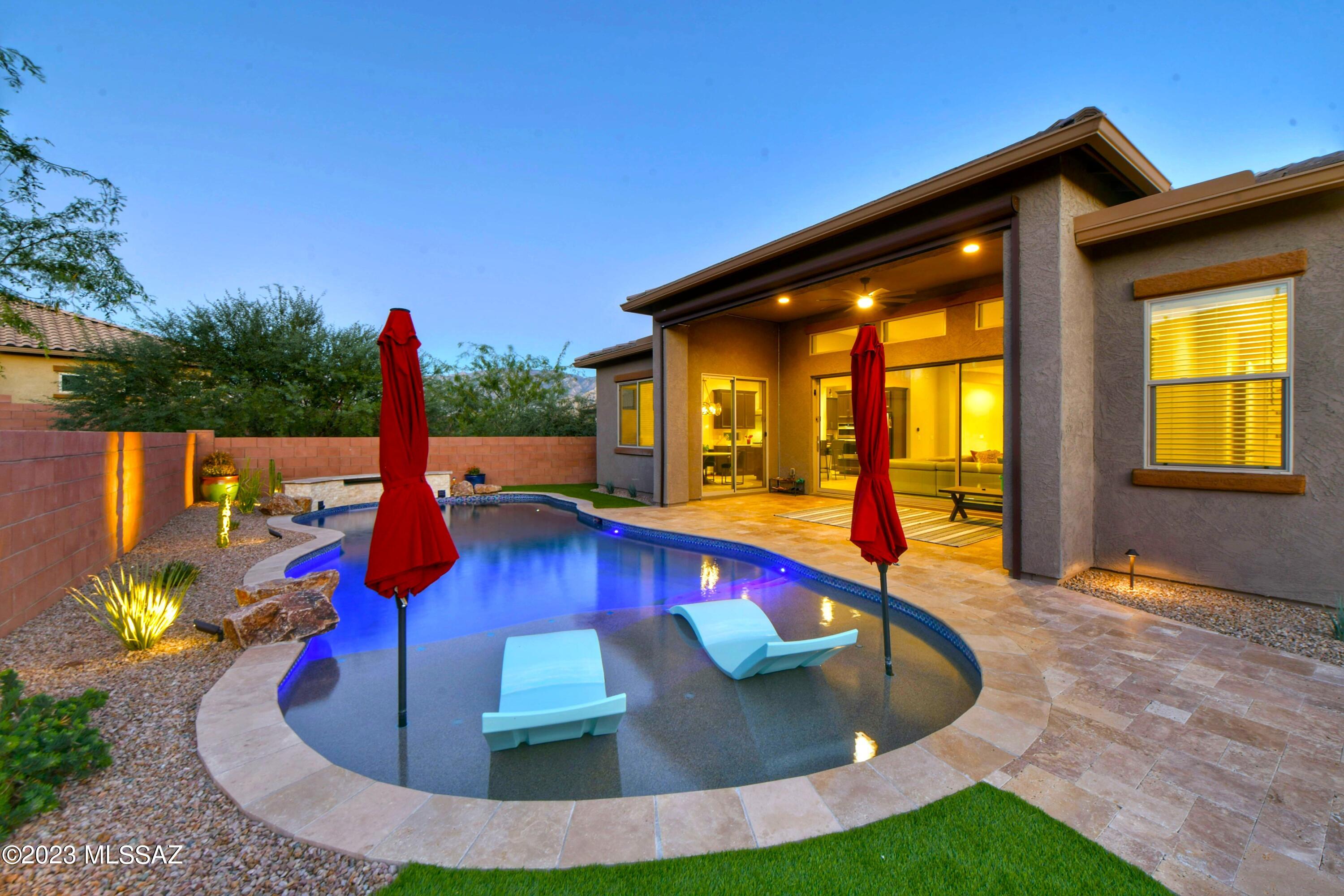 This Bright & Beautiful Cimarron Model Home in Gated ''Alterra At Vistoso Trails'' Neighborhood has it all! Desert Contemporary Style, 2,901 sq. ft. 4BR / 3BA + Office, Open Floorplan w/ High Ceilings, Gourmet Kitchen w/ Island, Granite Countertops & Tile Back Splash, Walk-in California Closet Pantry, Open Dining Room and an Expansive Great Room w/ a Lovely 15' Glass Slider that opens to your Private Rear Yard Oasis. Relax & Enjoy the Charming Covered Patio, Sparkling Pool w/ Waterfall, BBQ Island, Fire Pit w/ Seating & Mountain Views! Your Large Master Suite has Gorgeous Walk-in Shower w/ Spa Niche & Huge Walk-in California Closet. Entering from the 3 Car Tandem Garage, you have a Stop-n-Drop & a Large Laundry Room w/ Storage Galore. This is a Fabulous Oro Valley home!