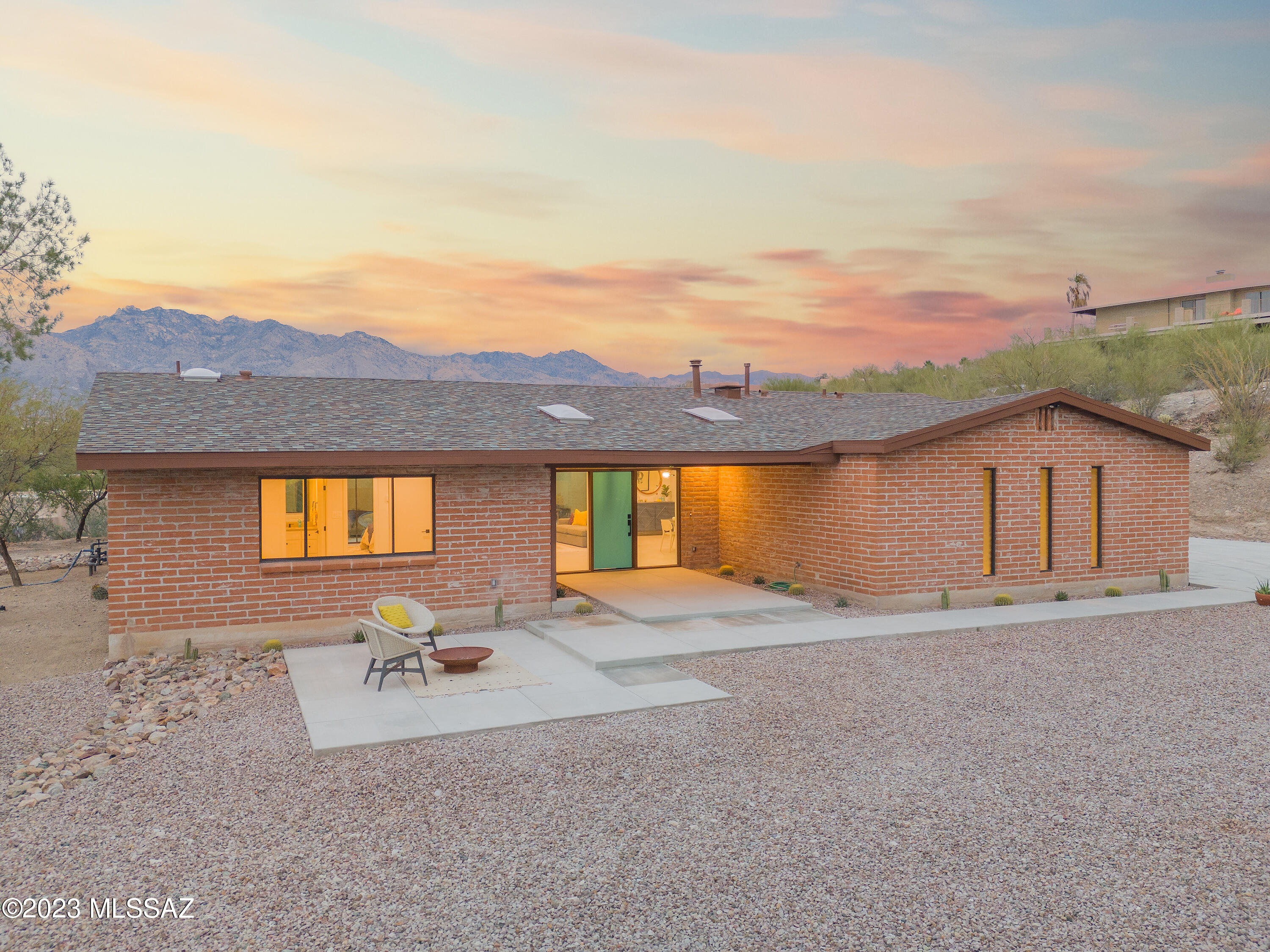 With breathtaking views of the Catalina Mountains and a fantastic location just minutes to shopping, Sabino Canyon, and Tucson Medical Center, this completely updated home is a delightful mix of Tucson character and luxurious finishes. Tile flooring throughout compliments new cabinetry, quartzite countertops, and copious natural light. The open kitchen has stainless appliances, a cozy coffee nook, and offers a large pantry/laundry space adjacent. New windows and expansive sliding glass doors to the patio invite the outdoors in, and capture the views from nearly every vantage point. The large great room is perfect for entertaining or simply enjoying our unparalleled Sonoran Desert climate. Three very spacious bedrooms, two with en-suite bathrooms, all have views to city lights or mountain ridges.  The pool has been replastered for years of enjoyment and extensive upgrades to this home make it ready to call home.