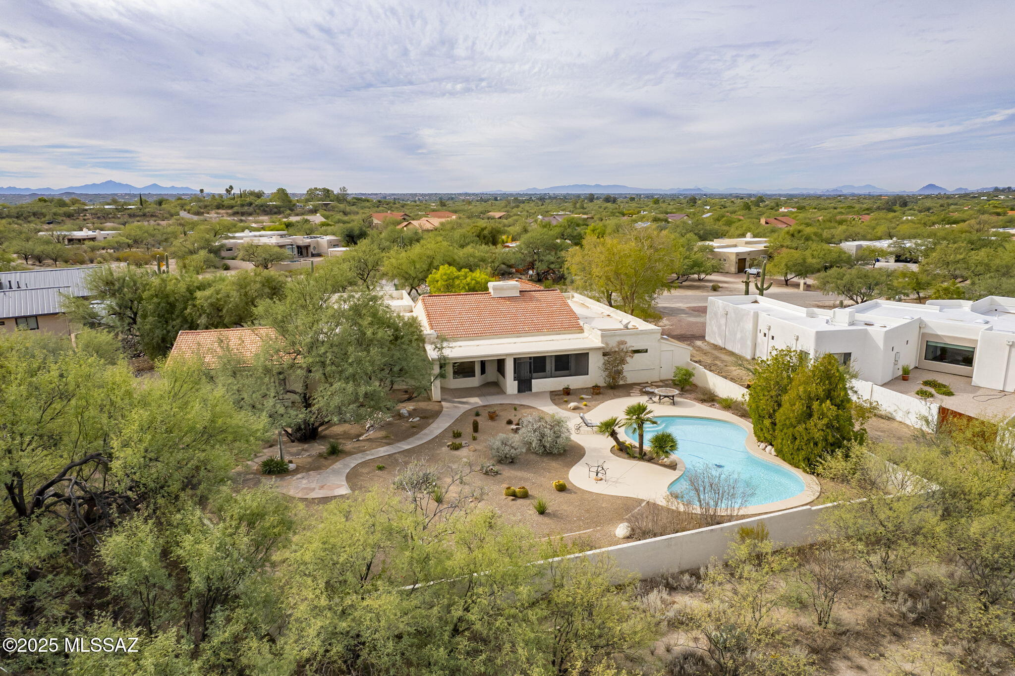 This spacious home in NE Tucson provides an elegant and peaceful setting with amazing views of both the Catalina and Rincon Mountains located in an established neighborhood of well appointed homes on large lots. A walled front courtyard with a soothing fountain welcomes you into a spacious and dramatic light filled central living space with soaring tongue and groove ceilings, a dramatic double sided fireplace and a view to the backyard pool and Catalina Mountains.  The permitted addition of 762 square feet with a separate entrance and separate patio is ideal for an art studio, guest quarters or office area. The home has been re-roofed, the pool decking recoated, a new double gate and new garage door opener installed.   NO HOA. Transferrable termite warranty. The  price per sq. ft. is dramatically lower than recents sold homes in this neighborhood which allows buyers to do any upgrades they desire.

For outdoor enthusiasts Agua Caliente wash and hiking is within walking distance with trails to Agua Caliente Regional Park, a unique 101-acre park that features a perennial warm spring and pond that is home to an exceptionally rich mix of plants and animals.

Shopping, restaurants, horse boarding facilities all within a 10 minute drive.

WONDERFUL OPPORTUNITY IN A GREAT AREA!