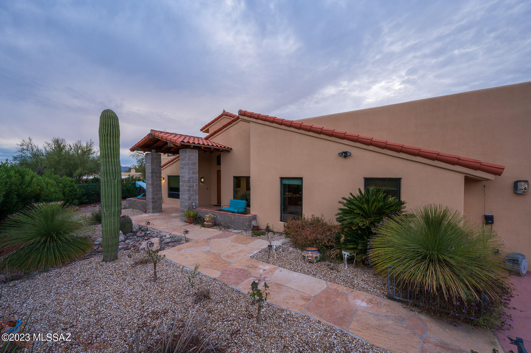 This absolutely stunning home is a showplace and entertainer's delight!  Tucked away in desirable Northwest Tucson, this open-floorplan home with majestic mountain views offers everything from privacy to elegance! The Primary Suite offers mountain views and a humongous dressing room closet that will take your breath away!  Use your imagination for two flex rooms on each side of the house, in addition to a large guest suite with full private bath and outside access.  The chef's kitchen has it all, with an exceptionally large pantry and plenty of storage available.  You'll find a large hobby room with an impressive miniature town train set filling the room, and the third bedroom boasts a music room/recording studio.   Continued... Flex rooms can easily convert to bedrooms, office space, or anything you need!  Outside boasts a private area with spa, and on the other side an above-ground pool with custom deck in the oasis yard, landscaped with many flowering plants, decorative palms and cacti.  A large Arizona Room has been custom built with an upscale, impressive chef's kitchen and entertainment bar.   The spacious lot behind the fenced back yard offers privacy, and could be cleared and even used for horses!  This house is a Tucson gem and a must-see!