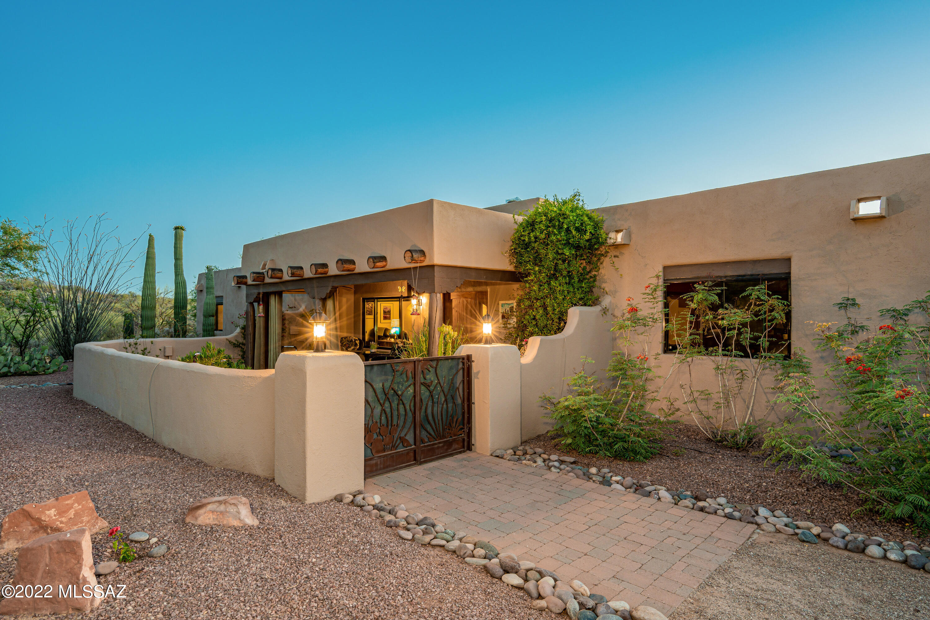 Your Desert Sanctuary awaits in this one-story Santa Fe nestled on nearly 3 acres in a quiet cul-de-sac, backing to 367 acre preserve in gated Redington Ranch Estates. Backyard paradise boasts sparkling pebble tec pool w/waterfall & solar heat, stunning city & mountain views, outdoor built-in kitchen/BBQ gazebo. Front patio oasis is perfect for enjoying shaded desert views. The beauty continues inside w/custom architectural touches throughout, gorgeous beehive fireplace, vaulted wood vega beam ceilings & Mexican tile details. Luxurious kitchen w/hickory cabinetry, granite & SS, 3bd w/walk-in closets, den/office space, Impressive Master Suite w/access to 2 patios, closet built-ins, new garden tub. Unique community includes optional horse facilities, tennis, a pond, clubhouse & pool!