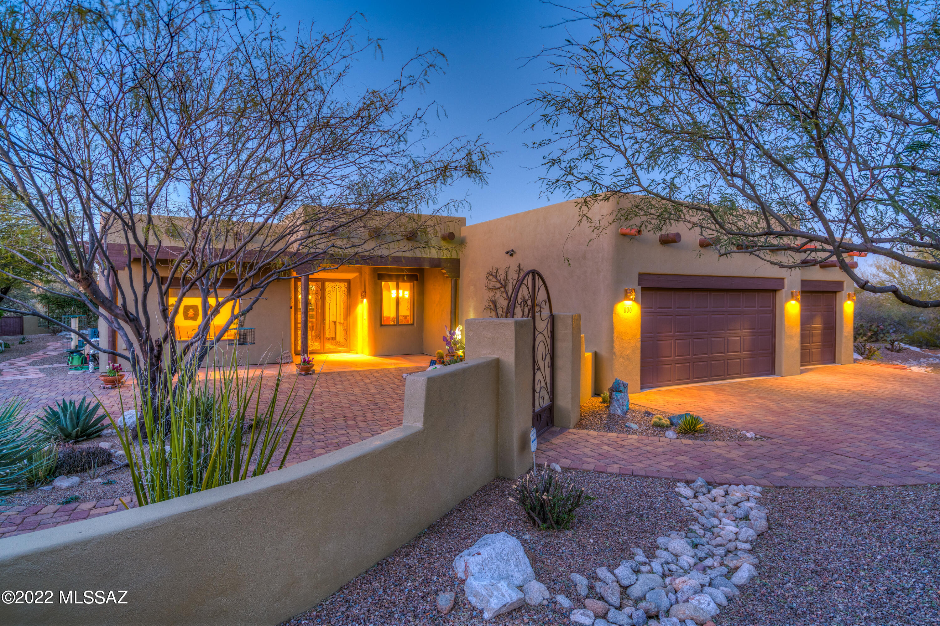 The 360 roof top patio with AMAZING views of the canyon & mountains is just the beginning in this exquisite 3 bedroom 2.5 bath split floorplan with an oversized garage & fully fenced yard (front, rear & side patios with custom gates in which to enjoy bird & wildlife, garden (rain catchment system) or entertain friends).   This home is a fusion of great architecture & nature with two water features, roll down blinds and more.   Classic sophistication abounds in the open concept floorplan—the great room has custom beams, a kiva fireplace & opens to banquette dining & custom extended cook's kitchen (Viking Range 6 burner gas range, convection oven, granite countertops with hand-chiseled edge, venetian plaster custom hood, custom backsplash, walk-in pantry).  See upgrades list for more detai Lovely dining room with custom walls by Sally Richards. Den with doors and beams that looks out onto front patio.  Two guest bedrooms flank a guest bath.  Primary en suite is modern tranquility with old world charm.  Wired for solar. Anderson Windows. Tesla charging station.