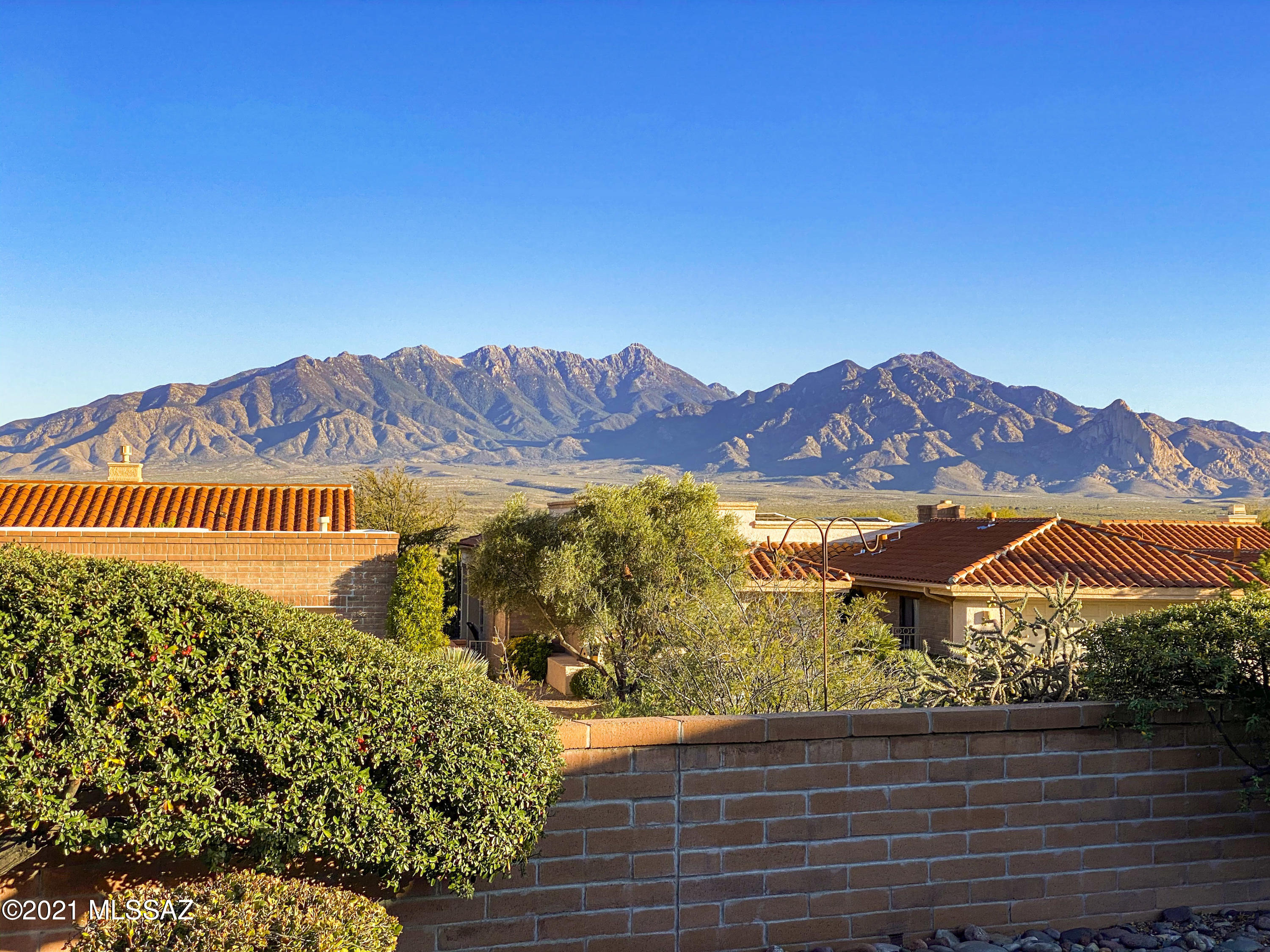 A charming palm and towering ocotillo will beckon you into this beautiful home situated high in San Ignacio Heights overlooking the majestic Santa Rita mountains. Follow the pathway through the front gate to arrive in the private courtyard. Enter into a large great room with soaring vaulted ceilings and light pouring in from the back patio. Immediately you will notice the breathtaking mountain views which are visible from nearly every room in the home. A formal dining room sits off the main living space with direct access to the breakfast nook and kitchen. You will love the modern color palette in the kitchen with stainless steel appliances and custom lighting. Off the kitchen you will find a bonus family room with a built-in entertainment nook. In your master suite, you will love relaxing in the soaking tub or large walk-in shower. And you will never tire of waking up to the beautiful view! Down the hall is a true guest suite complete with a custom murphy bed and wall unit to make it easily converted to a home office when needed. You will have a front row seat to enjoy the famous Arizona sunsets over the Santa Ritas every evening. Welcome Home!