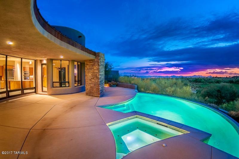 Exquisite 4BR/4BA 3,500sf gated Contemporary with Southwest flair boasts  stunning Tortolita mountain, golf course and sunset views! Situated on the 13th Fairway of the GALLERY NORTH COURSE in the private RIDGE AT SOLANA in Dove Mountain. Open concept plan affords luxurious amenities such as Travertine tile, floor-to-ceiling View Windows, and two-way indoor/outdoor Fireplace. Gourmet Kitchen hosts Stainless Steel appliances, Granite countertops and  island, plus circular Breakfast Nook with views. Guest Bedroom with en suite can double an an Office. Bonus Room in garage. Fabulous outdoor oasis features sparkling pool w/spa, fireplace and uncompromising views. Ideally situated between the Gallery Golf & Sports Club and Ritz-Carlton Resort. Owner will consider a trade (local/national).