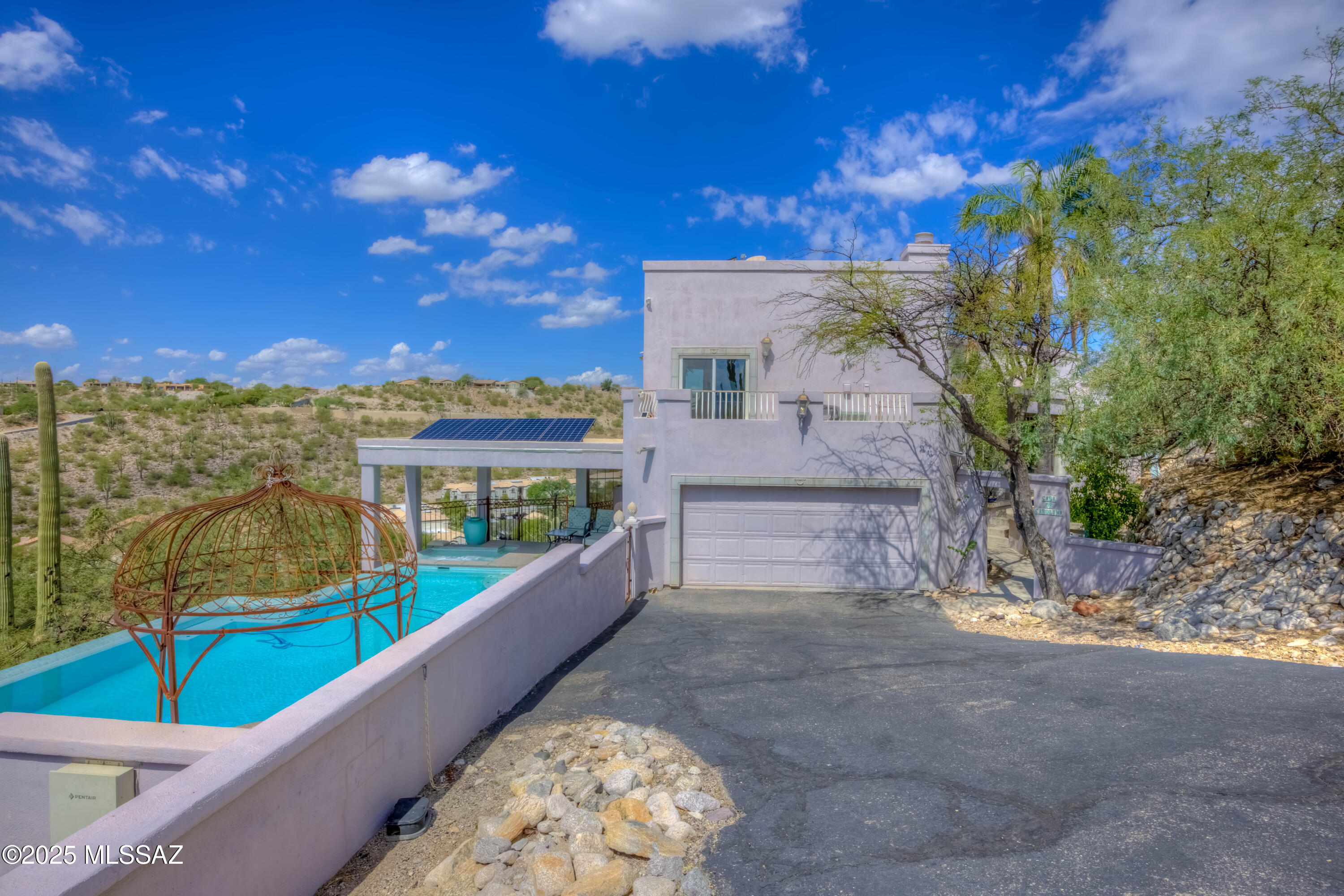 Custom Luxury Home in Prestigious gated community of Rockcliff. Welcome to 4545 Quartz Hill Place a stunning custom-built residence tucked away in one of Tucson's most desirable areas.  Perfectly situated near the scenic beauty of Sabino Canyon, this home seamlessly combines elegance, privacy, and modern design.  Step inside to find spacious living areas with soaring ceiling, expansive windows that bring in natural light, and refined finishes throughout.  The chef's kitchen is designed for entertaining with high-end appliances, custom cabinetry, and open flow into the dining and living space.  Outdoors, experience true resort-style living.  The infinity-edge pool overlooks sweeping mountain and desert view, creating a serene backdrop for sunsets, gatherings, or quiet relaxation. Must See!