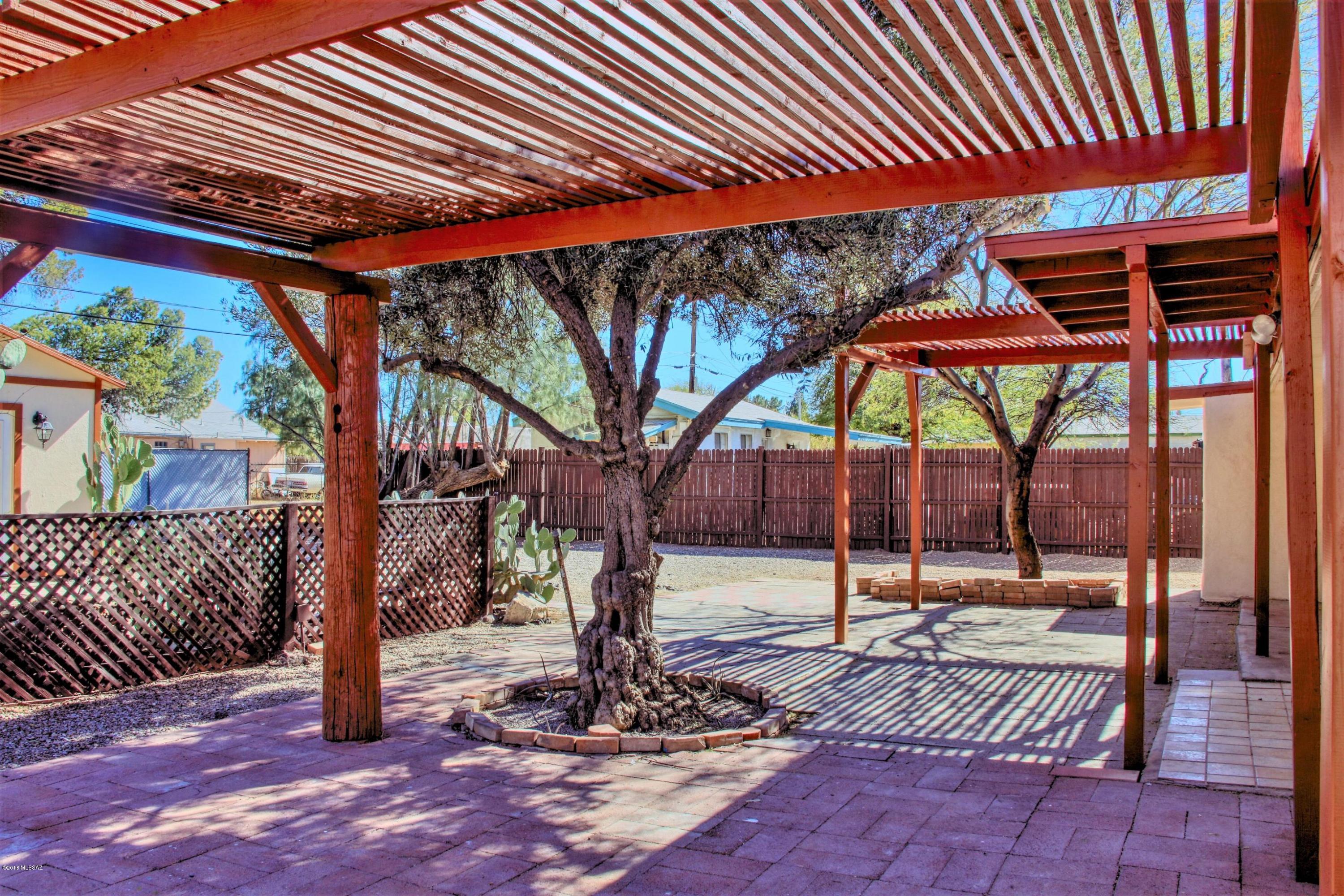 Amazing fully remodeled home in central Tucson. This home has it all. Newly remodeled kitchen, new appliances, beautiful stained concrete floors, 3 bedrooms, 2 full bathrooms, separate dining and living areas, big laundry room, new A/C, big back yard, RV parking on both sides of the house, gigantic 12X20 outdoor workshop and much, much more. Backyard boasts mature trees that provide ample shade, covered patio, and room for a pool. This home will not last long!