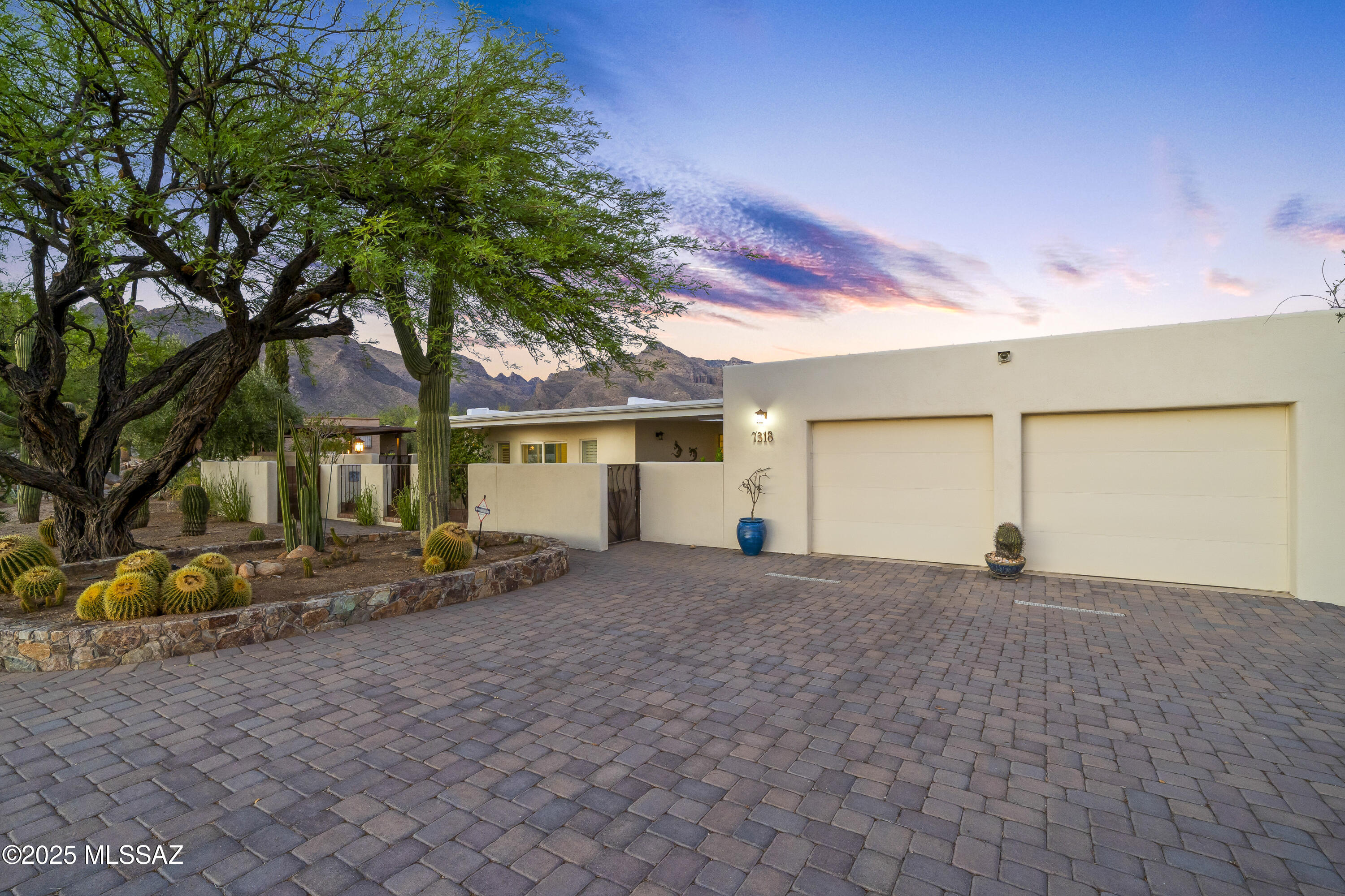 Fantastic opportunity in coveted Catalina Foothills Shadow Roc neighborhood. Beautiful paver driveway welcomes you to a gated courtyard & peaceful waterfall. This reimagined territorial boasts a lovely kitchen that was featured in Tucson Lifestyle magazine.  Both functional & stylish, it's perfect for preparing gourmet meals or casual snacks. Both bathrooms have been  updated, offering a spa-like retreat w/luxurious finishes & fixtures.  Inviting backyard has multiple seating areas, an outdoor kitchen, fireplace, sparkling salt water pool, spa & shower. Expansive mountain & city views from patios overlooking open desert spaces w/ever changing colors. Fabulous space for hosting intimate gatherings to large celebrations. Close to shopping, schools & Pima Canyon hiking.  Truly lovely.