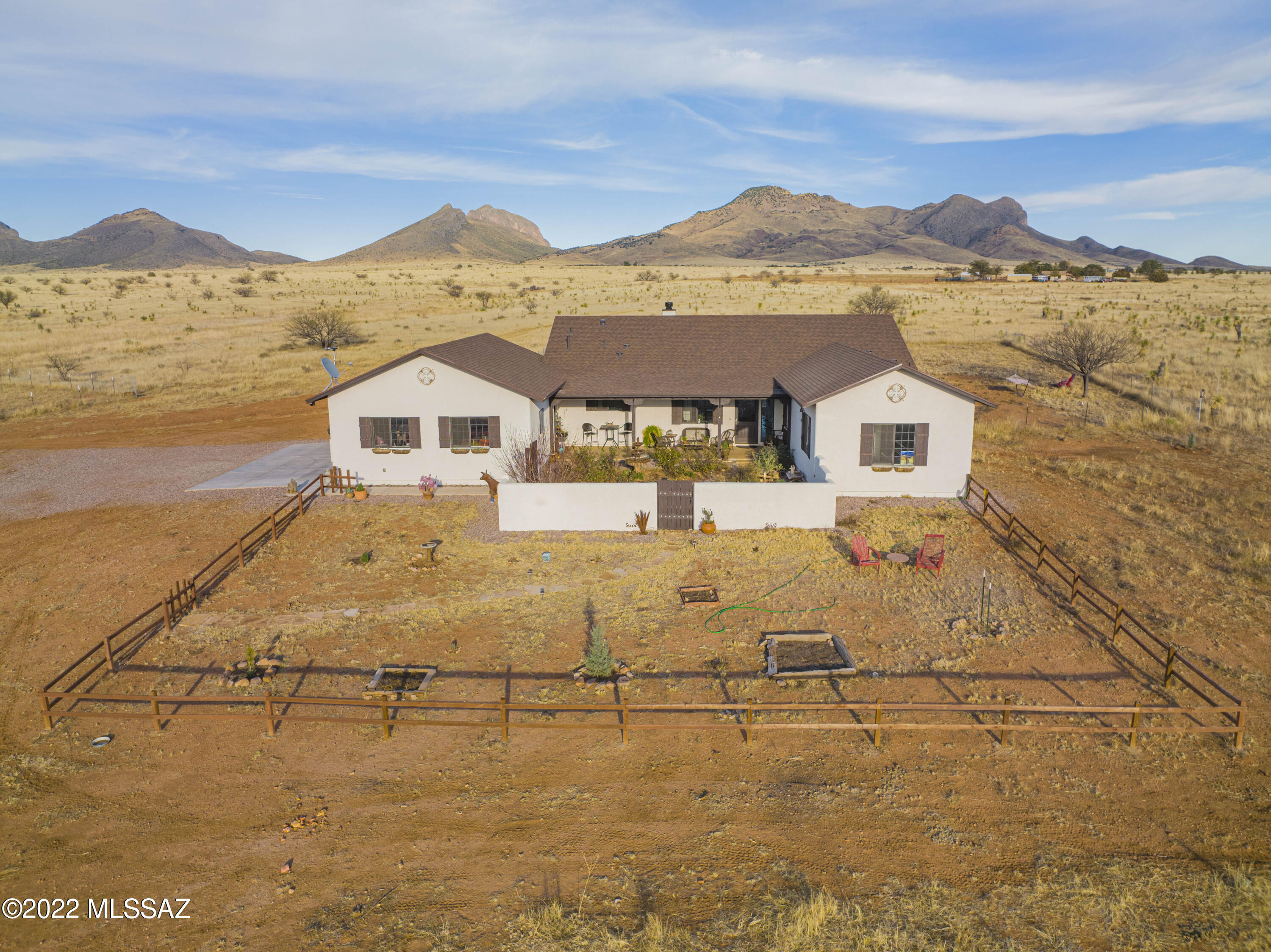 Located at the base of the Mustang Mountains in the heart of the Elgin / Sonoita wine country sits this three years new 15 acres horse property. The property has it's own private water well, horse facilities and room to grow. The horse facilities have two 10' x 20' loafing sheds, a tack room, hay shed, and storage shed along with a round pen and arena with about 12 acres fenced with 4 strand bard wire. The house is perfectly situated with it's long covered patio to take advantage of the Mustang Mountain views and dramatic sunsets.  After a great morning ride you can retreat to your soaking tub in the main bedroom or maybe jump out to the hot tub on the patio. The inside is one of the best great room plans I've seen with the kitchen on one end and the wood burning fireplace on the other.