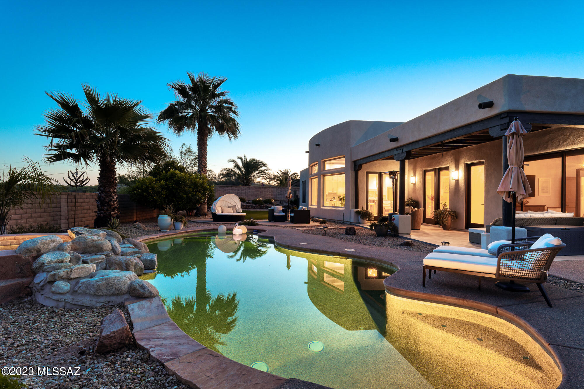 Stunning Southwest Contemporary in gated Pusch Ridge Vistas.
This home has undergone an impressive end to end transformation. Open floorplan with soaring ceilings and wood Vigas, light filled kitchen, open and airy with abundant cabinet and drawer space.  4bedroom/3bathroom along with 3448 Sq Ft features Restoration Hardware lighting and primary bath cabinets. All bedrooms are generous in size with spacious walk in closets. Both fireplaces feature floor to ceiling tile.  Laminate waterproof wood flooring with 5 1/2 baseboard, along with marble and tile flooring in all three bathrooms.  Tiled front entry and back patio space bring the lovely interior colors outside for more aesthetic beauty. Expansive views from front and backyard.  Front courtyard boasts Catalina and Pusch Ridge Views. Heated pool and spa, outdoor cooking area with built in grill and cooktop.  Three large citrus trees, lemon and orange that produce wonderful fruit.  A large area of artificial turf, extended back patio with sonos. Several concrete pads for additional seating and umbrella areas.  All attached tv's and soundbars convey with property. Please see feature list in documents.