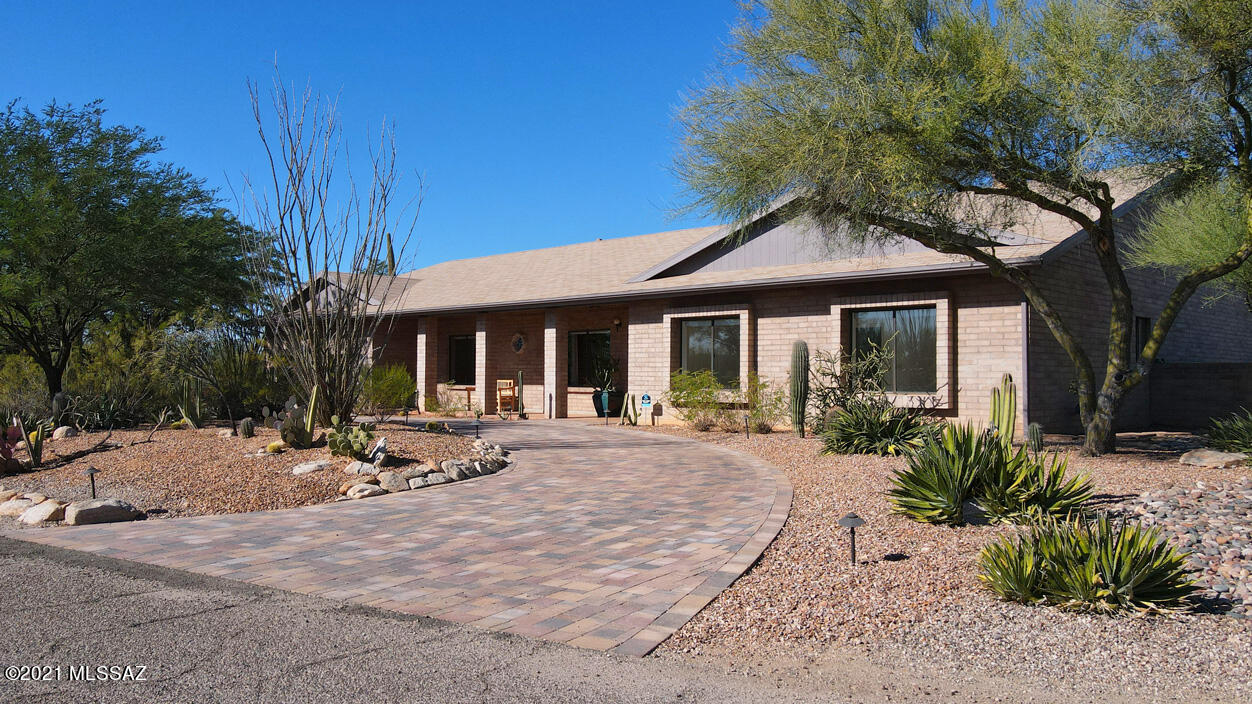 Spectacular Catalina Mtn views abound in this totally remodeled hm.  N/S orientation on a quiet cul-de-sac w/complete privacy is enjoyed inside & out.  Beautiful & practical ceramic wood tile floors are found throughout w/dramatic vaulted ceilings, walls of windows & glass doors.  Lrg, open living spaces flow seamlessly.  The chef's dream kitchen boasts 2 sinks, gas cooking, quartz counters & an abundance of stunning custom cabinetry.  Lrg great rm w/floor to ceiling brick fireplace & those captivating Mtn views.  Lrg romantic mstr suite w/access to the private hot tub, lrg custom walk-in closet, dual vessel sinks & lrg walk-in shower.  Bonus rm offers endless options. Built-in BBQ ctr, lrg covered patios, hot tub & fenced in dog run in rear yard.  2 &1/2 recreational car garage w/storage.