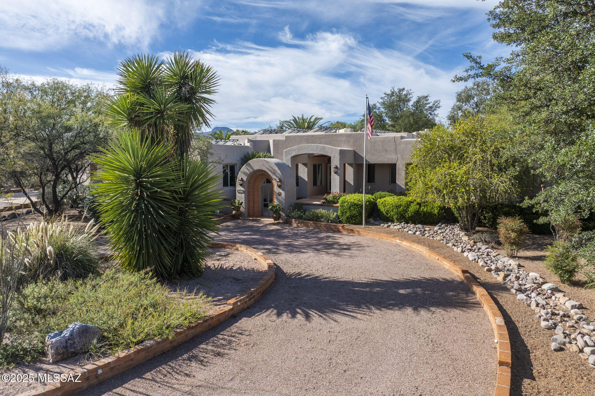 Nestled within the Tubac Valley Country Club and set on nearly one acre of lush, mature landscape—with towering shade trees and palms—this impressive 4,406 sq. ft. residence blends old-world charm with refined modern finishes. Featuring 4 bedrooms and 5 bathrooms, the home is constructed with insulated concrete forms (Rasta R-40) which provides exceptional insulation and designed for effortless entertaining.

A circular driveway welcomes you into a peaceful courtyard with a fountain, guiding you to the elevated grand entrance. Inside, soaring ceilings, a warm color palette, and expansive gathering spaces immediately capture your attention... SEE MORE Every detail has been thoughtfully curated to balance high-end luxury with everyday comfort, creating a home that truly embraces the Tubac lifestyle, back patio is a private oasis where you can lounge by the pool, grill on one of the built-in BBQs, or simply take in the tranquil surroundingsonce you settle in, you may never want to leave. Walls of Andersen windows frame stunning views and seamlessly connect the interior to the outdoors. The designer kitchen features custom wood cabinetry, mesquite countertops, top-of-the-line stainless appliances, and multiple pantries perfectly suited for hosting memorable dinner parties.

A charming guest casita, complete with its own entrance and patio, offers a welcoming retreat for visitors or an ideal space for a gym or hobby room. Beyond the exceptional indoor and outdoor living areasincluding multiple fireplacesthe property includes an oversized, climate-controlled and ventilated 3-car garage with epoxy floors, ample storage, and a utility sink. A private well and a large owned solar system (approximately 50 panels) help significantly offset utility costs.

This is a remarkable home that must be seen in person to be fully appreciated.