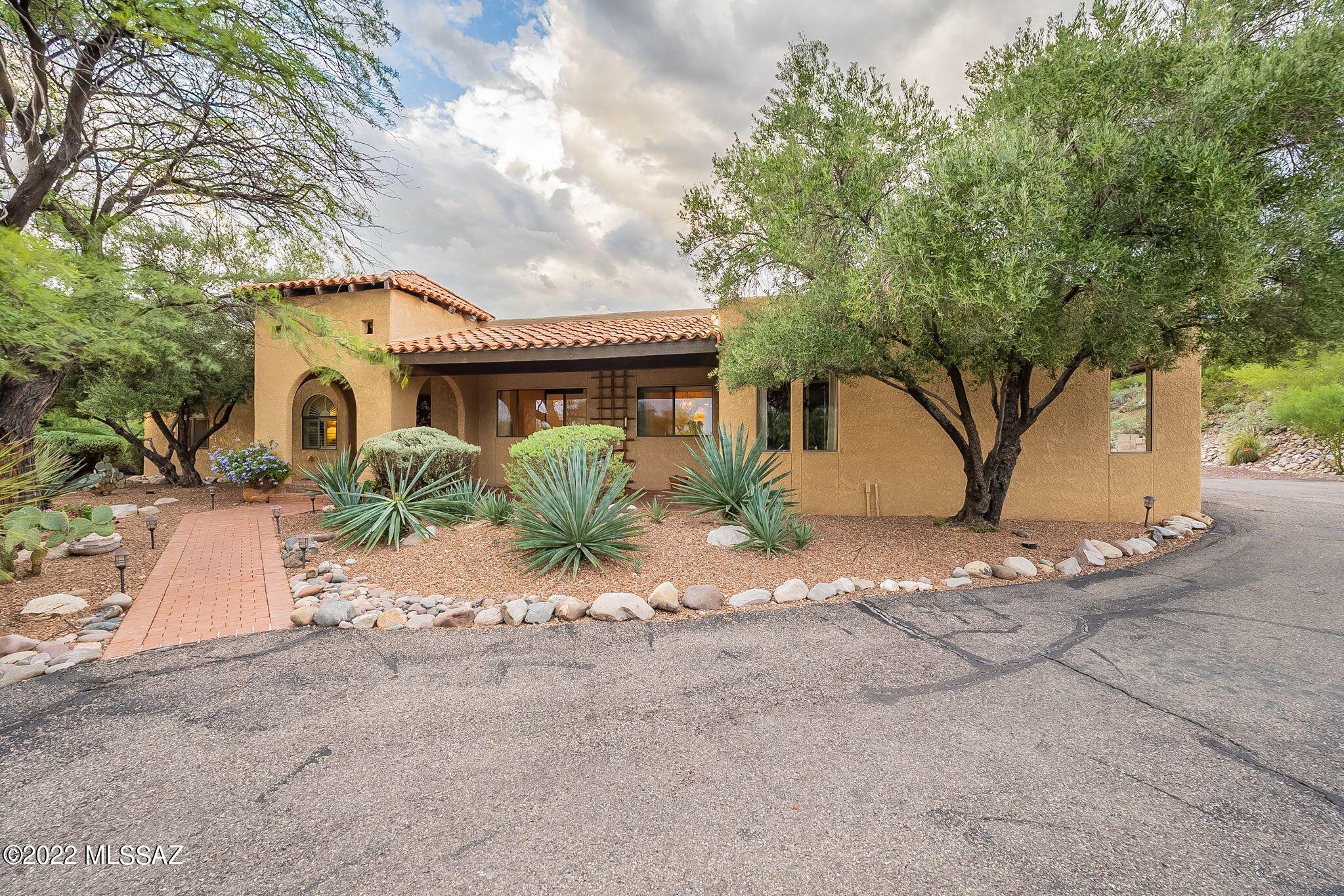 Magnificent 5 bedroom and 3 bath Catalina Foothills Home! This updated foothills abode features breathtaking Mountain Views. Sits just shy of an acre and is surrounded by lush desert with mature vegetation. Vibrant, resort-like backyard, with sparkling Pebble Tech heated pool, waterfall, porch, kids play set, water slide and a fire pit for gatherings! Family room includes a cozy fireplace and beamed ceilings. Kitchen with granite countertops, expansive storage, updated cabinets. Dining room with arched doorways & large windows with city views. Spectacular surround sound theater room. Suite off the kitchen has its own bathroom, with upgraded tile and rain shower. Expansive Master Suite bathroom and walk in closet. Roof has 34 owned solar panels. Power port for Electric Vehicle Charging. Brand new AC unit installed 8/18/2022