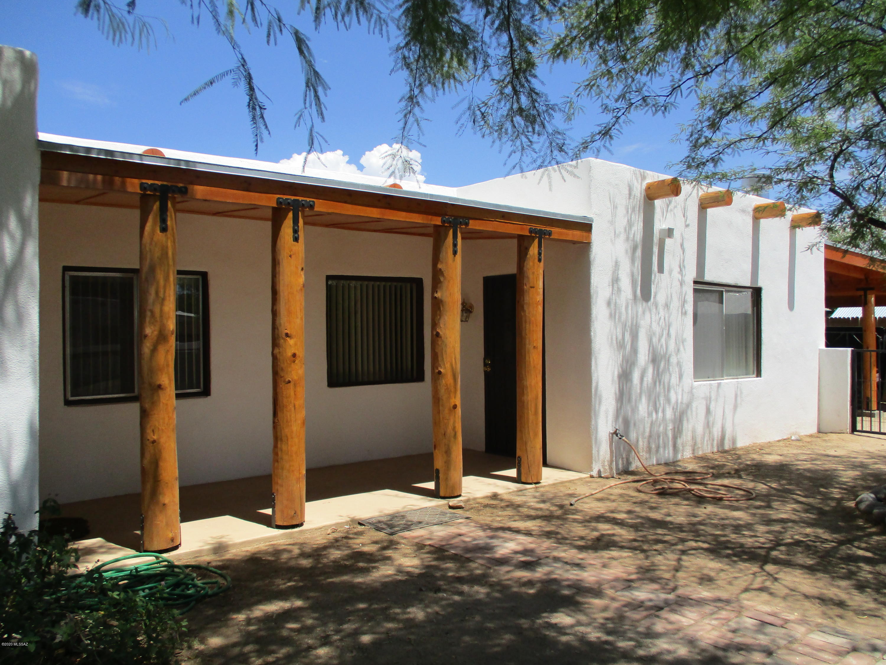 Adorable unit with great ceramic tile throughout. Beehive Fireplace (Wood Burning), Covered back porch w/ pavers, Enclosed front and back yard. Secluded, quiet location. Santa Fe Style Architecture Appearance. All utilities are included except Electric and Cable.  Has artificial turf in the backyard, One Covered Parking Spot
