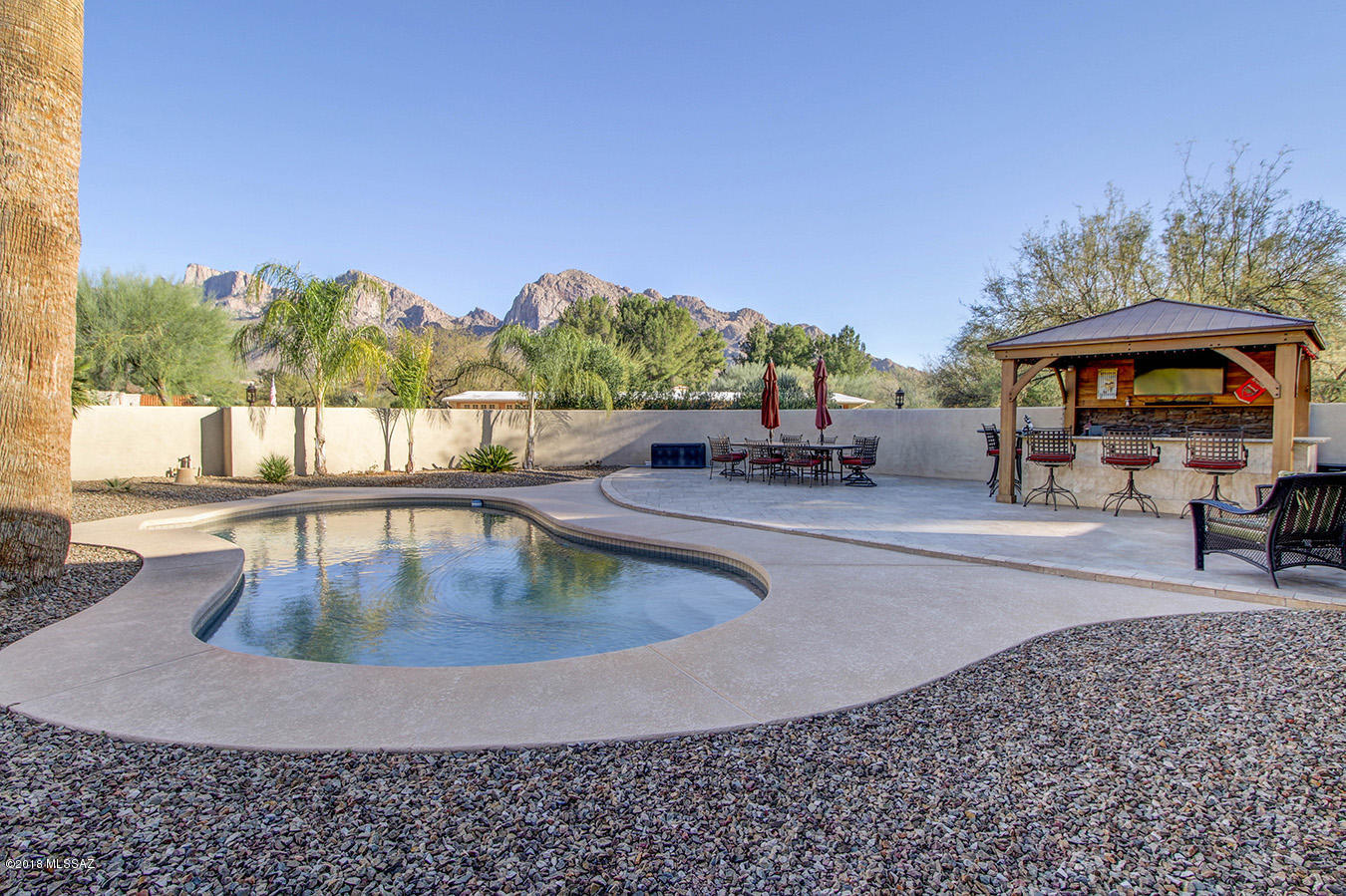 Location, Location, Location.  Home sits on the 7th green of OV Country Club and boasts of gorgeous sunset views from the front, majestic mountain views from the backyard and golf course on 3 sides! Built solid in 1965 and tastefully upgraded galore with many designer touches!  Hard to find split bedroom floor plan. Huge master bedroom, walk-in closet for her and slider closet for him!  4bdrm/3ba! Master bath w/ beautiful custom tile work & oversized walk in shower. 3 additional  bdrms.  2 sharing hall bath & 1 with own sep bthrm.  Kitchen w/ granite counters, SS appliances & cherry cabinets opens to both great room & living room.  Separate formal dining area.  All w/ beautiful travertine flooring.  Pebble tec pool, outdoor kitchen w/ bar area & 750 sq ft of turf.  Entertainers dream!