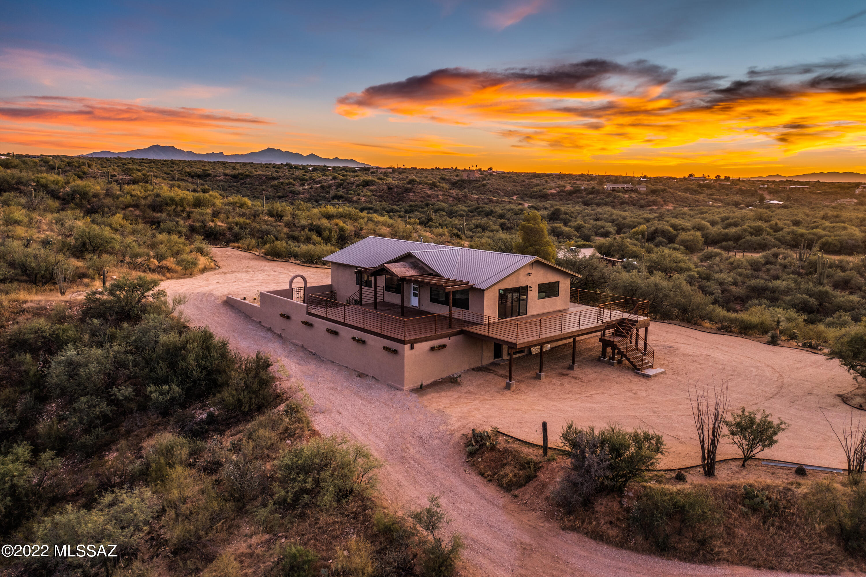 Enjoy the breathtaking views of the Rincon mountains, sunsets, and desert landscape in this beautiful 4bed/3bath home located in Rincon Valley Ranch. The home has been completely remodeled inside and out. Including a brand new open kitchen with a long quartz calcutta island which is perfect for entertaining. New cabinets with plenty of storage space, new 6 burner range, tile backsplash, quartz countertops and energy saving SS appliances. New flooring throughout the house with new large windows that provides amazing views along with a natural modern look. The formal living room has new french sliding doors that provides easy access to the new (sq footage) Trex deck porch. The primary suite has a spacious walk in closet with built in drawers, and a new tiled shower with dual shower heads. Walk downstairs to the family room with a second kitchen, laundry room, two bedrooms, and bathroom perfect for those cozy family nights, or for visiting guests for that extra comfort and privacy. The exterior of the home has brand new stucco and paint along with a new Trex deck that was built so you can enjoy the amazing views. Sitting on 5 acres you can turn your backyard into your own personal paradise!. The property has space to build a garage/carport to store vehicles and RVs or a horse facility. There are plenty of hiking trails nearby and outdoor exploring including colossal cave mountain park, Rincon mountains, and saguaro national park. The land is also rich with wildlife and beautiful desert landscapes. This unique home is truly one of a kind!