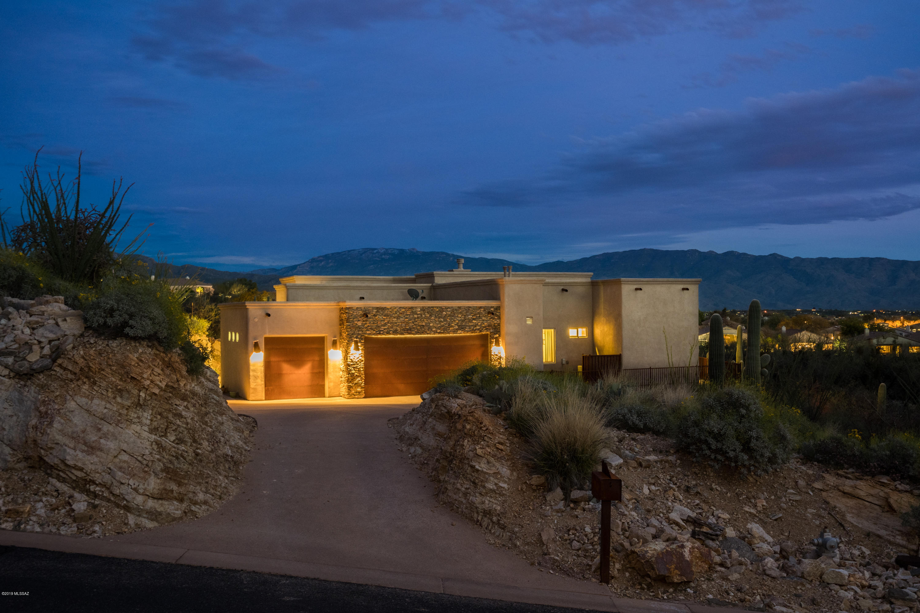 Enjoy the view of the 2nd hole of Arizona National Golf Club and City lights from your backyard. Mountain Views can be seen in the front yard. Once you get in the semi-custom home you will find travertine tile, granite countertops, and custom paint. The gourmet kitchen comes with upgraded stainless steel appliances, large island for entertaining, fully loaded theater room and an outdoor kitchen.
