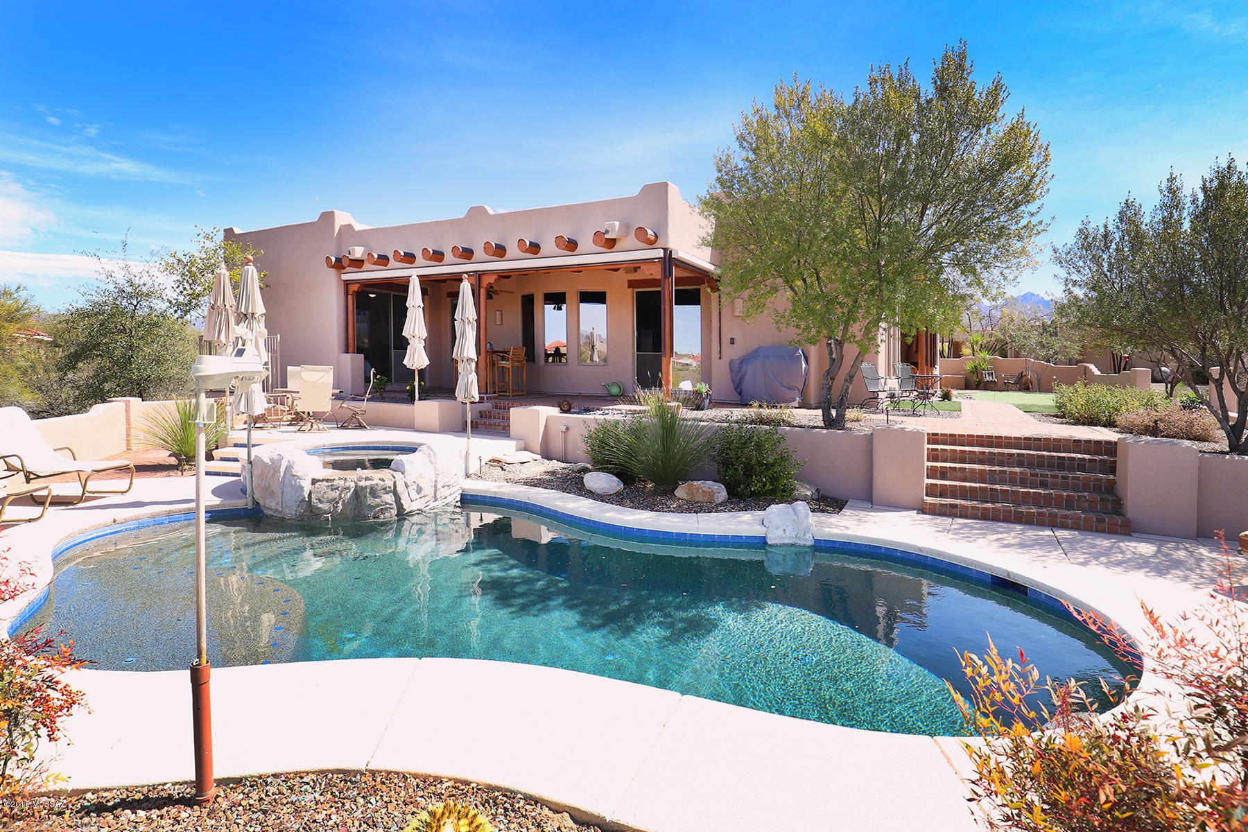 Stunning Santa Fe home with Casita located in the Estates at High Mesa a small gated custom home  community. Home borders acres of natural desert on over one acre home site. Wonderful courtyard entry, viga beams, vaulted ceilings, beehive fireplaces, wet bar with refrigerator and ice maker and master suite with sitting area. Wrap around patio with fireplace to view amazing sunsets, solar heated pool and spa. Just completed whole house exterior paint and roof coating.
Enjoy wonderful southwestern living from this truly Impeccably kept home!