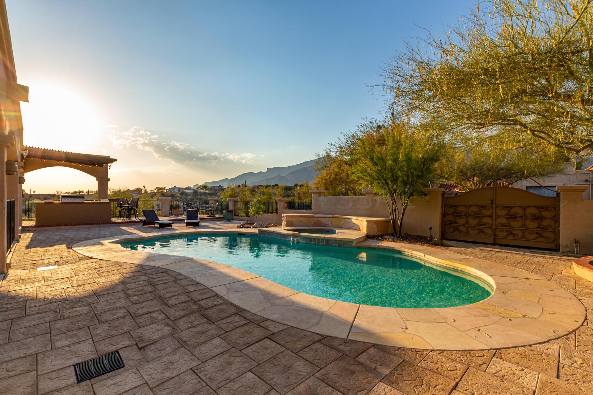 Amazing high lot with city and mountain views. Spacious property with 4199 sq ft of living area .4 Bedrooms, 3 1/2 bath home with engineered hardwood flooring, new carpet in bedrooms and family room.  Open bright living room with Mountain views. Formal dining room. Large game room with built in bar counter. Chef's kitchen with Kitchen Aid Double ovens, and 36'' gas range, Granite counters.  Wine Room off kitchen. Master suite with fireplace. Remodeled Master Bathroom with Double head shower and surrounded with custom tile. The best backyard mountain views you have seen with a Salt Water Pool & Spa with new pool equipment.  Outdoor Kitchen and bar to entertain. Front side area has turf grass with a firepit area with city lights to look at . Open House Saturday June 19 10:00 am - 3:00 pm.