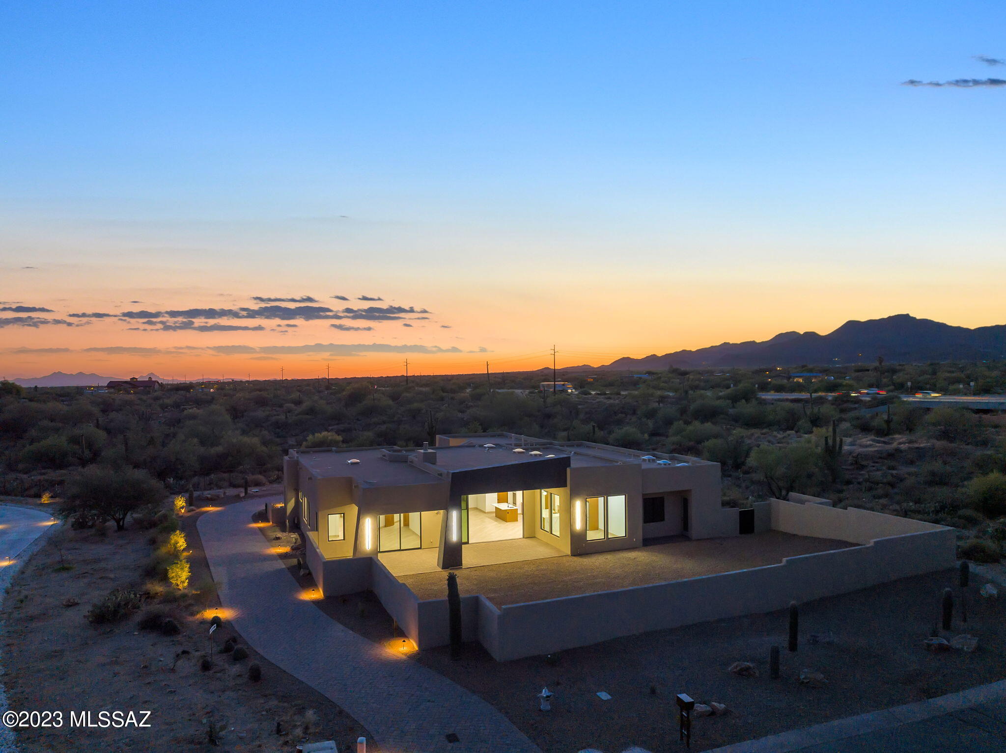Spectacular New Construction Contemporary on .83 acres in Oro Valley, by award winning builder Homes by Copper Canyon.  4 bdrm 3 1/2 bath home  with back yard facing east to capture Catalina Mtn views.  Entertainers delight with open floorplan that flows from great room to kitchen and dining nook.  Features include 15' Retractable sliding door, 5' glass pivot entry door with sidelights, 6' plank tile set on a diagonal thru out home, solid wood cherry stained doors, 10 skylights.  Kitchen features 2 Quartz islands, Zline stainless appliances, include 48'' professional 6 burner dual oven range, French door refrigerator, and built in microwave drawer. Primary bdrm Suite is stunning with soaking tub, walk in shower, spacious walk in closet and spectacular tile work. Home complete approx 4/10 3 secondary bedrooms all have access to a bathroom. Oversized 3 car garage in the rear of flipped house with paver brick driveway and patios.  Bonus room can be Media room, office or ? Landscaping starts next week and finishing touches. Custom home with highest quality construction without the wait. Backyard landscape design plan available.  Hurry to see this Beauty in Gated Sunset Canyon Estates, a small enclave of only 21 custom homes.