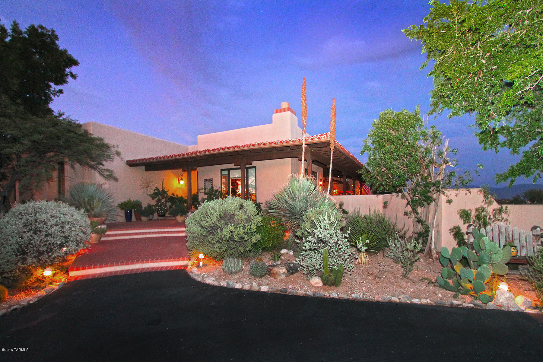This dramatic all masonry Spanish Colonial home built by La Quinta Homes & designed by architect, Michael Franks is sited on 1.65 acres w/unobstructed 360 degree Catalina Mtn & city views. This romantic home is filled with authentic details for the discerning Buyer. Enter through spacious foyer leading to living/dining room w/Saltillo floors, high ceiling w/hand-hewn corbel beams. Expansive kitchen is a chef's dream w/Viking 6 burner gas cooktop w/double oven & Sub-Zero refrig. Stunning master suite w/FP & large walk-in closet leads to private patio w/spa. Relax in warm,clubby den/library w/FP and seagrass sisal.
Multiple outside patios create intimate entertaining areas w/panoramic views. Expansive covered patio leads to pool surrounded by lush landscaping w/coveted city & sunset views.