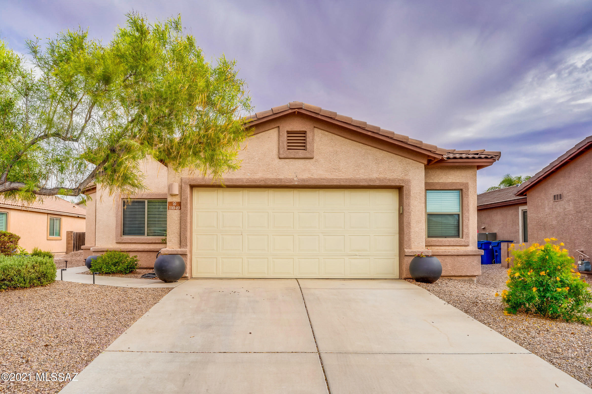 Beautiful home in the fast growing Gladden Farms community! This move in ready 3 bedroom 2 bath home was built in 2005. The home features an extended 2 car garage, granite counter tops, faucets, window coverings, custom paint, tile throughout the main traffic areas, wood laminate flooring in bedrooms, laundry room and a spacious back yard with covered patio. The TEP maintained solar system keeps electric bills low. This home is located only 1 block away from one of the many parks located in the community. It is 1.4 miles away from Gladden Farms Elementary School and a short distance to the community Splash Pad.
