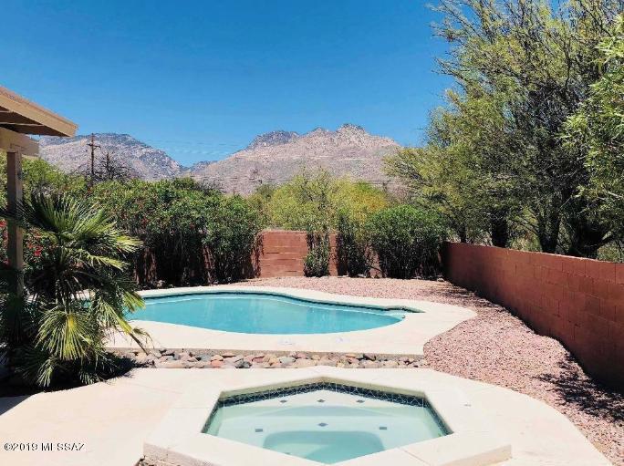This fantastic 3bdr/2ba house  is located in Catalina Foothills in  a quiet Cul-de-sac very close to Sabino Canyon.  High ceilings, polished Saltillo tile floor. NO carpet. Kitchen with granite counters and  stainless steel appliances, has a  breakfast bar that opens to a  great room with  beautiful mountain views  and  fireplace.  Very nice  backyard with conventional pool and spa. Can be rented furnished for 6-9 months. Prices may change.