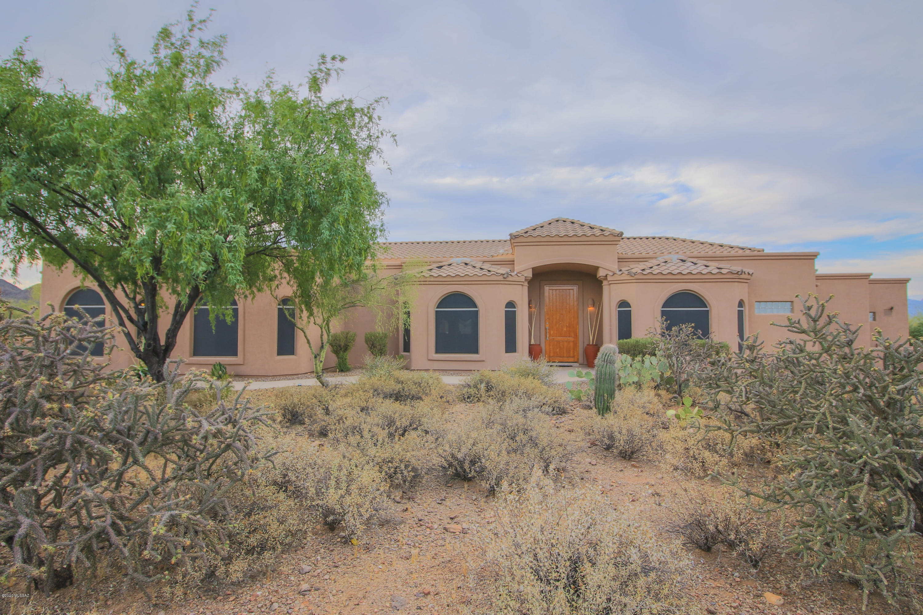 What a BEAUTIFUL Custom home in the gated community of Saguaro Cliffs! Perfect for those that like to entertain, or for the Family that likes to spend time together. Home is complete with a true theater/media room, huge Game/Recreation room, climate controlled 1000 bottle Wine room, along with the 4 bedrooms, 4 bathrooms AND 4 car garage. 3 Zoned AC units. Chef's kitchen with Cherry Cabinets, Granite Counters, Island, High grade appliances incl built-in fridge. Master Suite with dual sided fireplace & huge walk in closet.  Deep and extended patios, lagoon entry pool heated with solar spiral coils. Outdoor kitchen. Fire pit. Beautiful views of mountains. Quiet and peaceful. The lot extends from Saguaro Cliffs north to Trails End Rd. Check out remarks on the pictures for more details.