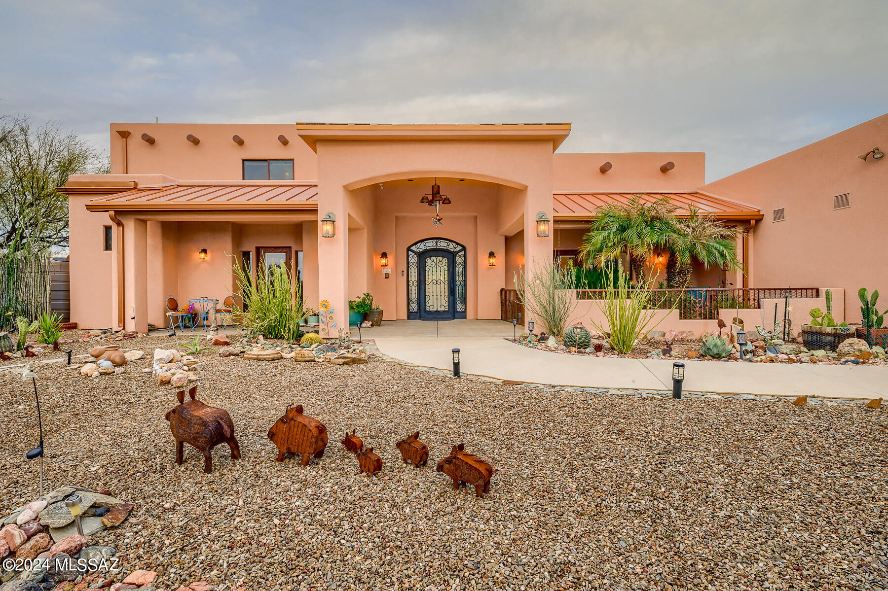 This residence stands as a true architectural  masterpiece!! Showcasing unobstructed mountain views from almost every rm. Contemporary interiors w/natural accents & art seamlessly embedded into the walls. Wheelchair accessible. Family rm w/dramatic 20 ft ceilings, polished concrete floors, gourmet kitchen, top of the line appliances, pantry & wet bars. Lux bath, jacuzzi tub & a generous master bedroom. Each room is a suite w/their own bath & patio. Oversized 3 car garage & a balcony overlooking the stunning Catalina mountains. Enclosed yard w/ramada, spa &play area. This home is a sanctuary of tranquility sitting on nearly 5 ac. of majestic saguaro land!  You'll find yourself in an isolated desert pocket w/an extremely unique peaceful solitude. Near finest amenities & restaurants & No HOA