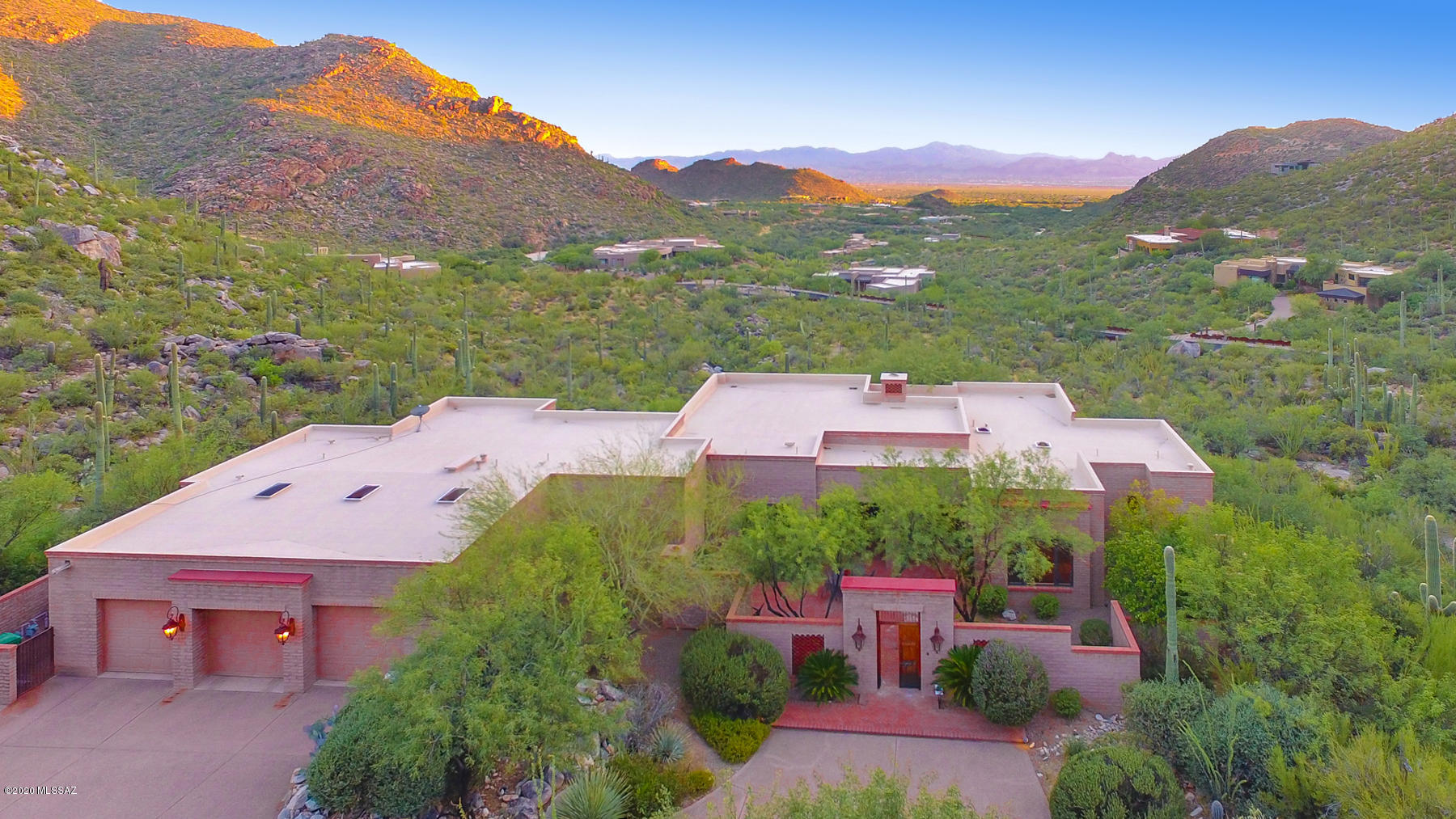Spectacular 4BD/3BA (3,741 sq ft) custom hillside estate boasts privacy and panoramic mountain and city views. Nestled against the Tortolitas in the luxury, gated community of Canyon Pass, a charming courtyard greets you with brick pavers, fireplace and fountain. Distinctive Great room boasts polished concrete floors, wraparound view windows, brick fireplace, formal dining area, and chef's kitchen with stainless appliances, granite countertops and island. Private Master wing hosts luxurious amenities and views. Guest wing offers 3 bedrooms; one w/courtyard access. Extended rear porch leads to a heated lagoon style pool/spa. Extended 3 car garage w/storage. Wood plank ceilings on patios plus serene views from every room! Dove Mountain is home to the Ritz-Carlton Resort & Gallery Golf Club.
