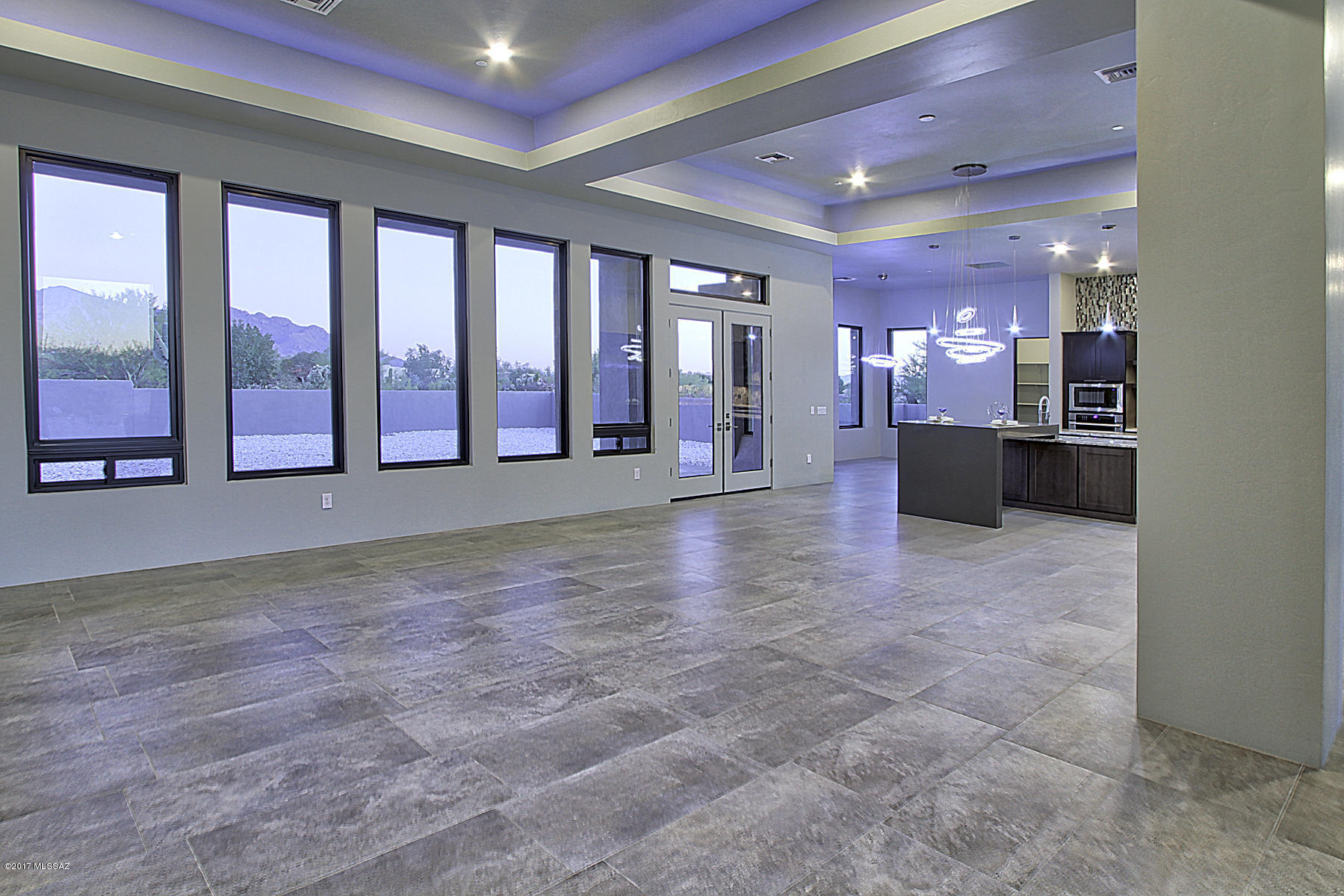 *Seller shall respond to offers in the range of $850k-$875k*  NEW, STUNNING 4 Bdm/4 Ba Contemporary Style Home w/Mesmerizing Pusch Ridge & Catalina Mtn VIEWS is Now Available!  In gated enclave of 17 custom homes, each on nearly an acre, natural desert is preserved. Bring your highest expectations to this richly finished home finely dressed w/level 4 Alaska White Granite, Charcoal Quartz waterfall edge island, Shaker style grey cabinets, matching 1 3/4'' Alder doors throughout, vogue crystal light fixtures, 18''x36'' 
porcelain floor tile, glass mosaic tile accent surrounds & dramatic to ceiling backsplash. 5'x10' Pivot glass entry   door provides uninterrupted viewing corridor from curb to serenity. Extensive 13' high cov'd patio beckons alfresco enjoyment of our Catalina Mtns & AZ Skies You have just found a very special setting in Oro Valley along the ever popular Tangerine corridor that is private, spacious and bordered by coveted riparian area where desert flora and fauna thrive.   From here, access many miles of walking/biking paths.  Gated private walkway to renowned Wilson K-8 school.  Quick access to I-10, Oro Valley Towne Centre, Golf Courses, OV Hospital & every type of service/retail.  If Chic Contemporary is for you, this home is a must see.  The attention to detail and top quality construction will satiate the most discriminating.  See for yourself that Sunset Canyon offers "VIEWS to live by"!
Rear yard design and install available.  Limited supply Sierra Mist landscaping rock from NV quarry is currently on front and rear yards of this premium VIEW lot.  A few more lots on which to build your designed home are available. Call for open house times or your private viewing.