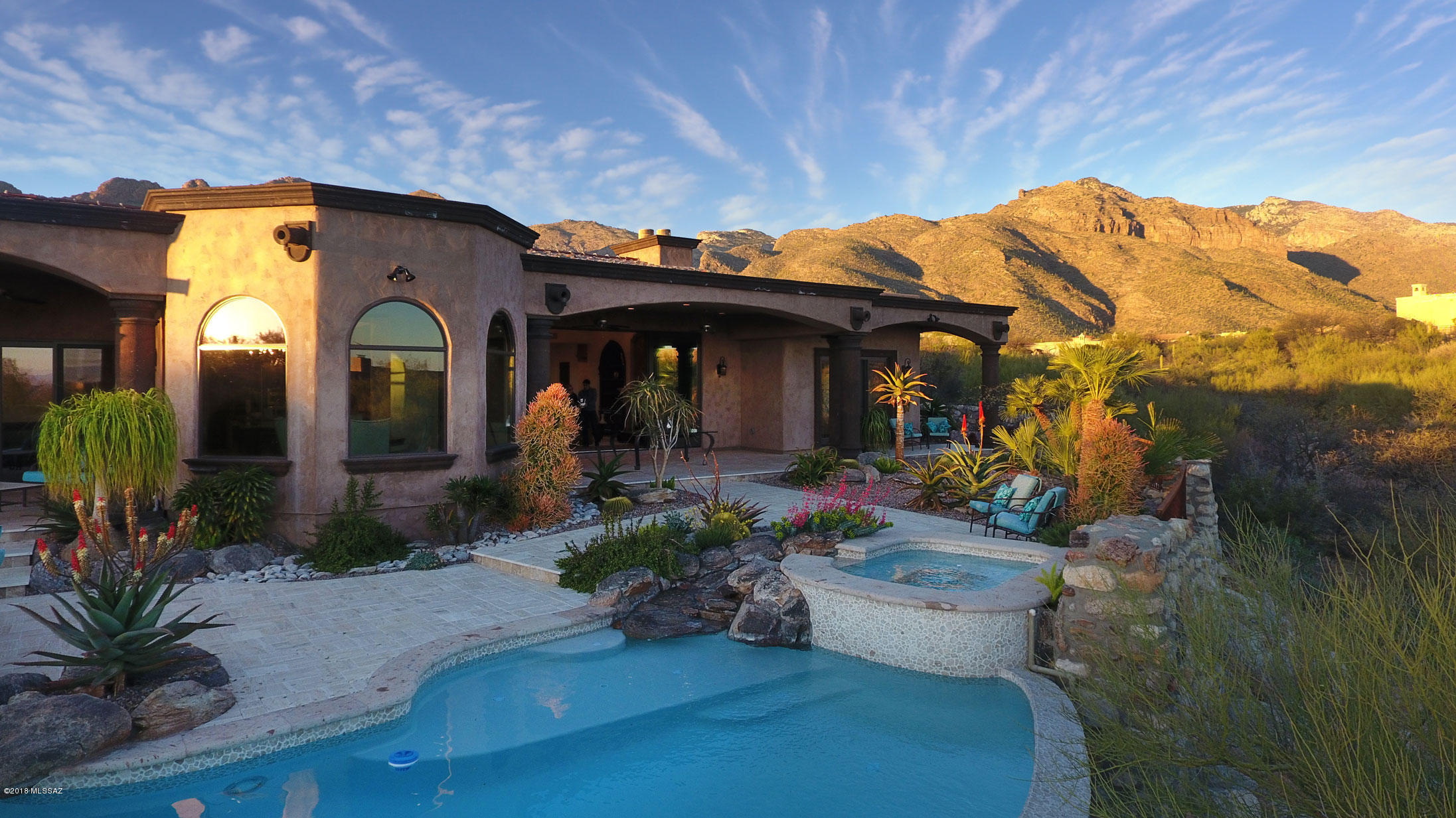SELLER WILL ACCEPT OR COUNTER OFFERS BETWEEN $1,699,000 & $1,999,000. THIS MAGNIFICENT STUNNING CUSTOM HOME BUILT BY BARTHOLOMEW HOMES IS BUILT WITH THE DISCERNING BUYER IN MIND. THE CRAFTSMANSHIP AND QUALITY OF MATERIAL USED IS IMPECCABLE.SNUGGLED WITHIN THE PRESTIGIOUS 24-HOUR GUARD-GATED COMMUNITY OF PIMA CANYON, AS YOU WANDER THROUGH THE STONE COURTYARD WITH CANTERA FOUNTAIN, UP TO THE AMAZING HAND-CRAFTED ENTRY DOOR,ENTER THIS HOME WITH SOARING CEILINGS, HAND HEWN WOOD TRUSSES &  CANTERA FIREPLACE ALL ALLOW FOR A BEAUTIFUL VIEW STRAIGHT THROUGH TO THE PATIO WHICH OPENS UP WITH THE EXPANSIVE 20’ COLLAPSING DOOR.ENJOY THE RESORT STYLE BACKYARD WITH NEGATIVE EDGE POOL/SPA. LARGE GORGEOUS CHEF’S KITCHEN WITH 2 ISLANDS TOPPED WITH BRAZILIAN GRANITE, 6 BURNER COMMERCIAL GRADE COOK-TOP A HIGH END APPLIANCES, LARGE PANTRY, WIDE HALLWAYS WITH CANTERA TRIM ROTUNDA AND MATCHING CHANDELIERS ON EACH END OF THE HALLWAYS. HANDCRAFTED CUSTOM 8 FOOT ALDER DOORS THROUGHOUT. LARGE MASTER BATH WITH ITALIAN MARBLE COUNTERS, LARGE WALK-IN SHOWER AND CLAW FOOT SOAKING TUB.  3-CAR GARAGE AND MAJESTIC MOUNTAIN & CITY VIEWS.  THIS IS A MUST SEE HOUSE.  PRICED TO SELL!!!
