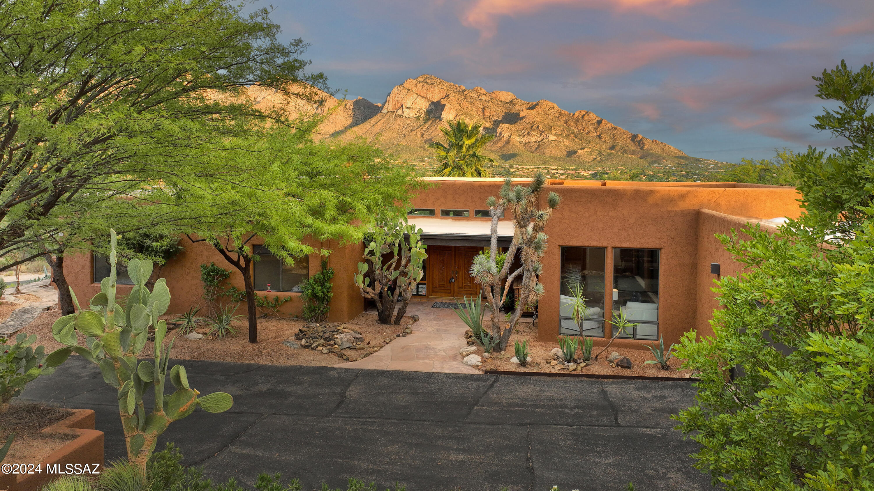 MOUNTAINTOP HOLIDAY HACIENDA - Thrilling Southwest rustic styling embraced by the Catalina Mountains & your very own private acre plus in unbeatable Oro Valley location. with sought after Southwest styling..  HOLIDAY MOVE IN POSSIBLE.  Enjoy  Oversized 3 car garage & comfortable hilltop parking for guests that urges you to invite a crowd.  Welcoming flagstone entry, heavy 15' rustic beamed ceilings & windows galore that expand your living spaces from this 3450sf ranch to include the massive covered and uncovered patios that wrap around the home and adds immense living space. Bright & Cheery kitchen has been updated some time ago with thick granite counters but it has kept  its charm by allowing Saltillo tile floors to remain.