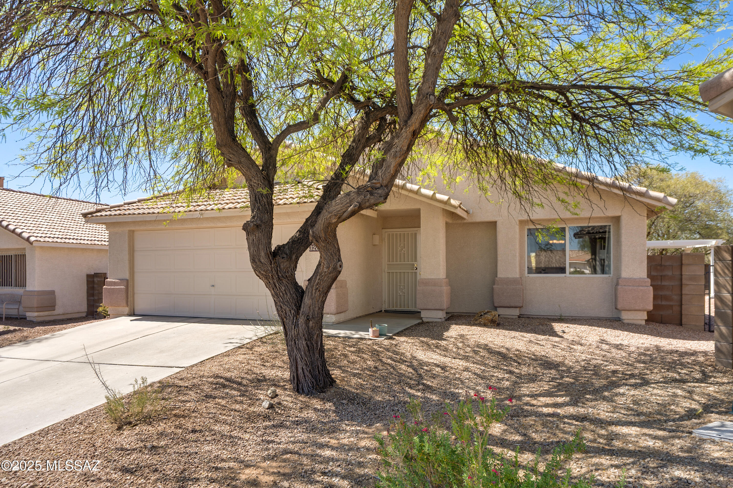 Welcome to this beautiful 3 bed, 2 bath, 1752 sqft home on a premium lot with no rear neighbors and stunning desert/mountain views. The spacious living room is filled with natural light, while the family room off the kitchen offers a cozy retreat.The kitchen features a breakfast bar, generous counter space, and plenty of cabinetry, flowing seamlessly into the dining area. The primary suite includes dual vanities, a walk-in closet, and private access to the patio. A second sliding door from the family room leads to a peaceful backyard with covered patio, pergola, mature trees, and extra seating areas—perfect for relaxing or entertaining. Quiet, desirable west side community near I-10, Silverbell Lake, shopping, restaurants, downtown and the UofA. Call today to see this gem!