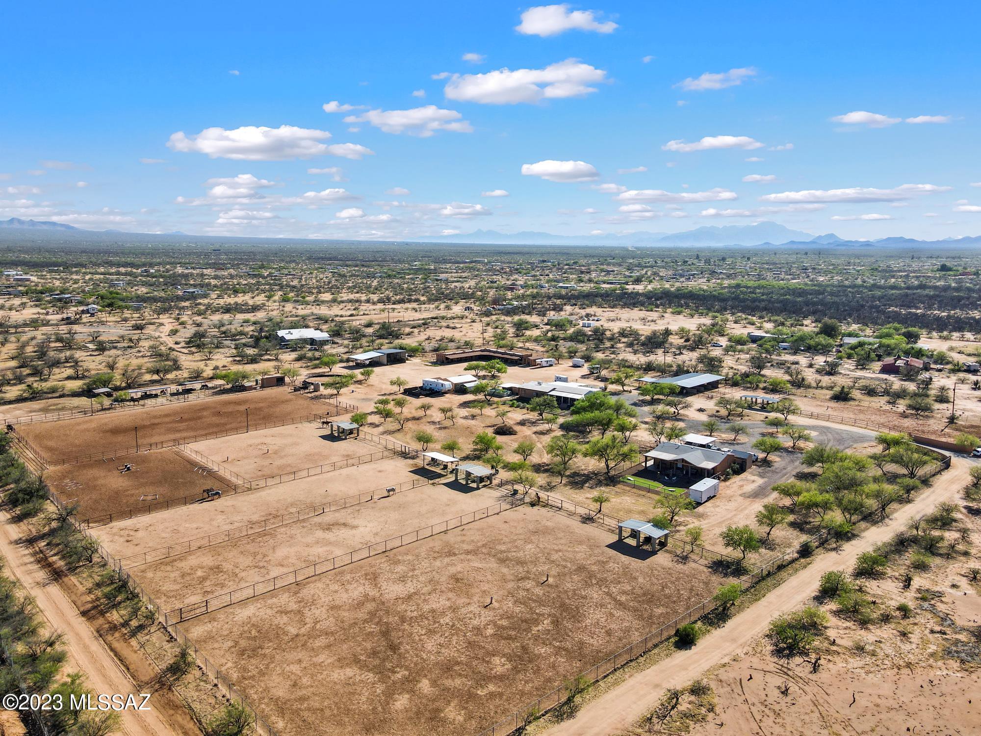 Horse lovers' paradise! Live in one house and rent out the other. Endless possibilities with this 10-acre operating ranch with 2 manufactured homes, 22 stalls, round pen, full arena with lights and cattle chute, hay awning, wash rack, 3 tack rooms, separate restroom for boarders, auto water in stalls, 8 pastures of various sizes. Live your dream of doing what you love! There are 16 boarders currently, 2 RV hook ups that are being rented and 2nd home that is currently being rented. Boarders pay $400 per month each. 2nd home rents for $1600 per mo. and RV spaces for $600 each. Grounds are very well maintained, water supply is by its own private well. Lots of room for additional boarding and horse events. Call for your tour today. Seller Carry Option, See Agent Remarks!