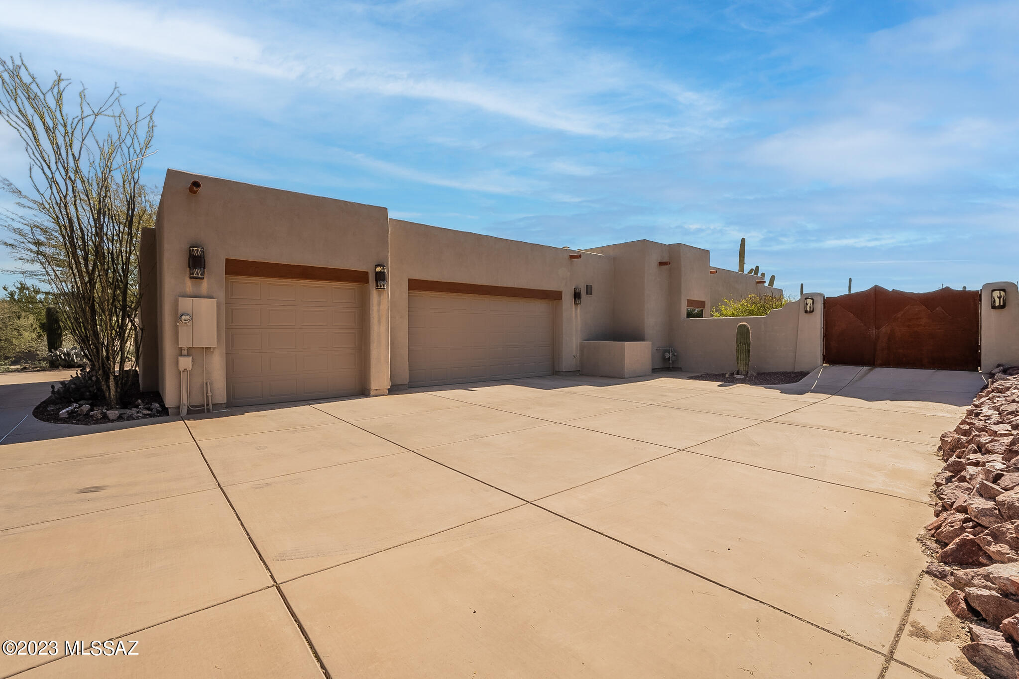 Stunning custom home on a gated 2+ acre desert lot with panoramic mountain views and low HOA. High ceilings and custom tile throughout, plus a huge gourmet kitchen with hickory cabinets, slab granite counters, and stainless appliances. Luxurious primary suite with office area and spa-like bathroom. Spacious living areas, formal dining, and private family room. Spacious, natural backyard with full length covered patio and breathtaking views. Oversized 3 car garage plus extra parking. Don't miss this unique desert oasis!