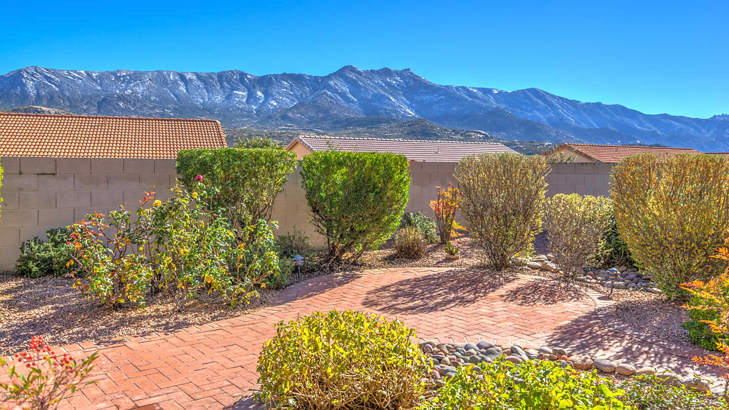 Terrific mountain views at an affordable price! This MADERA is the high vaulted ceiling version with 8 ft. sliders AND transom windows above. This allows mountain views to be seen & enjoyed from most rooms in the house, creating a light & bright feel throughout. The wood floors have been newly & beautifully re-finished. There’s carpet only in the two guest bedrooms. The laundry room is greatly enlarged with additional storage space & can easily serve as office or work space. Other features include: a powder room, fireplace, 4 electronic rolling outdoor shutters, new Vertiglides on sliders, new dishwasher, & new reverse osmosis system.  Just a fabulous house, superbly maintained, utterly clean & ready for your move-in!