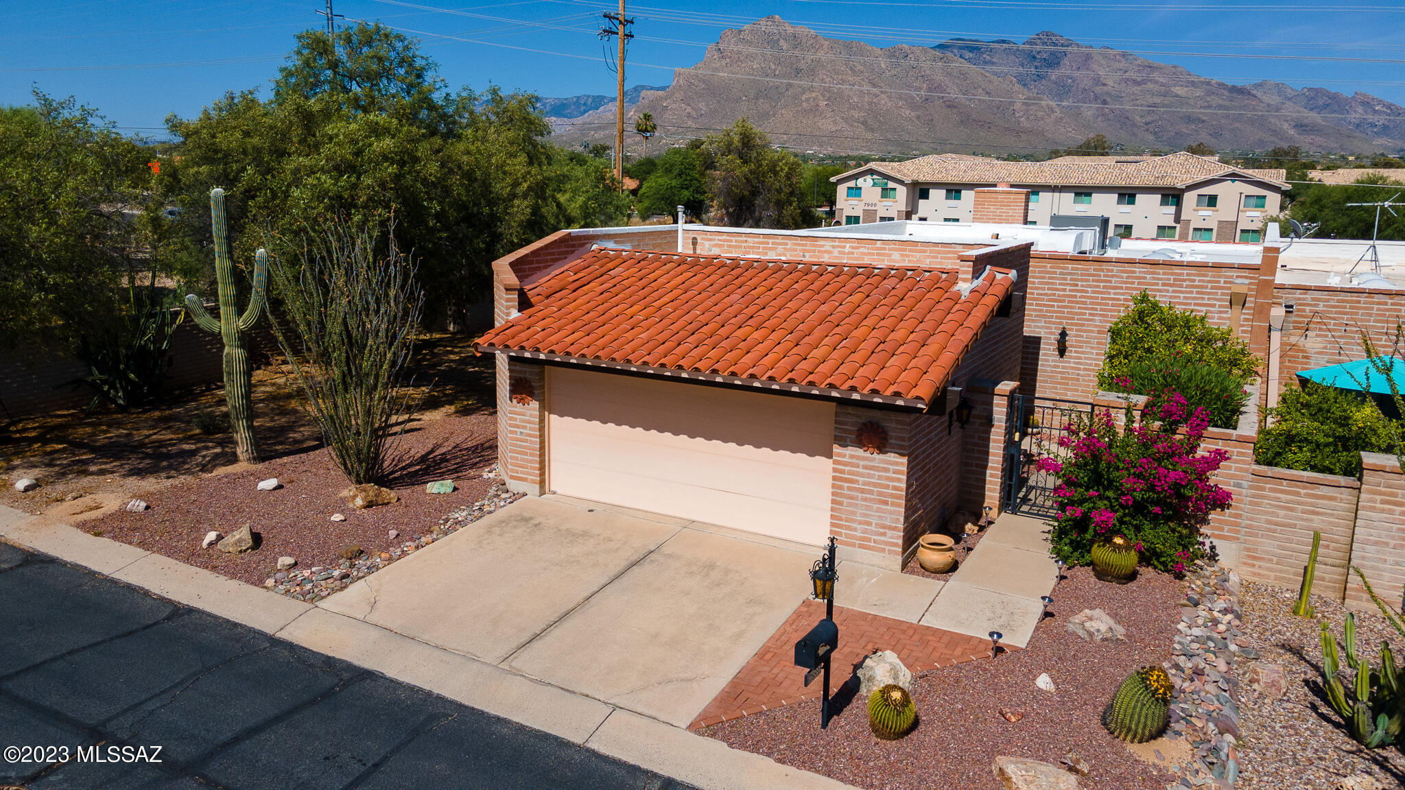 Welcome to the Villa De La Canada community! This meticulously maintained end unit townhome features an inviting 2 bed, 2 bath floor plan with a large family room and a quant updated kitchen. Recently updated Anderson windows throughout and 2021 HVAC will ensure you have a cool and energy-efficient home for the summer months. Enjoy sunrises and cool shaded evenings from the large wraparound patio with views of the Catalina mountains. The front entrance offers a private courtyard to welcome guests and is perfect for plant lovers! Community amenities include pool access, a park, and a tennis court. Schedule your showing now!