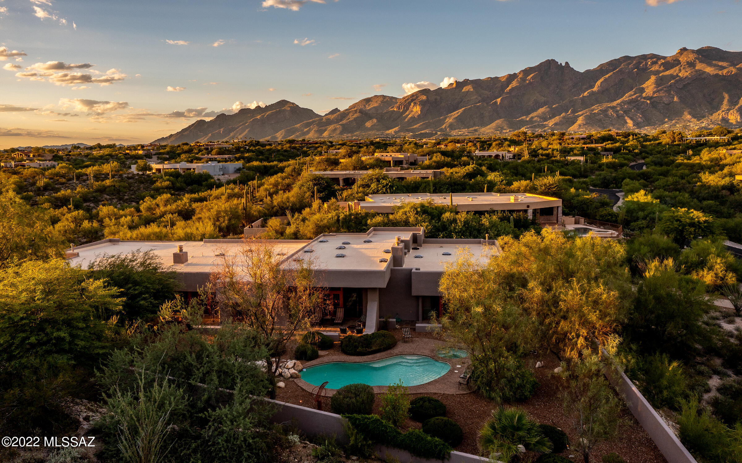 Luxury living at its finest in this Southwest Contemporary David Tyson design. This exceptional 4,912 sq ft home sits on a premium lot behind the guarded gates of Catalina Foothills Estates 10. Private lot features an extended driveway & guest parking. Enter into the galley foyer, an area perfect for displaying all your fine art work. The living/dining rooms are the heart of the home exuding both grandeur & warmth with the elevated ceilings, timeless finishes & open concept. The state of the art kitchen boasts a 6-burner Viking oven & an oversized granite topped island, perfect for entertaining! Positioned off the kitchen is the casual dining space & a comfortable family room... Two primary suites along with 3 generous sized guest rooms, each room enjoying their own private patio. Well landscaped backyard offering a refreshing pool/spa, soothing water feature & star gazing-sparkling city lights.
