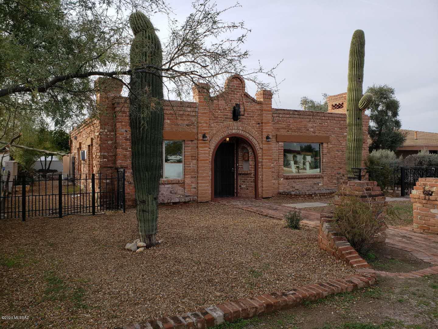 Check out this amazing Historic Home owned by the Tucson Feldmans! Like a little sculpted brick Castle, this home has been completely remodeled and updated to a modern home, without losing its historic charm. The main house features 3 bedrooms and 2 baths, while the guesthouse is a comfy studio with 3/4 bath. The main home features stainless appliances, granite countertops, huge walk-in room sized pantry, 2 fireplaces, New AC, new ceiling fans, all new low E windows, Walk-in master closet, new paint, real exposed beam ceiling and more! The guest house has granite countertop, AC, new wood look tile floor, and an all new bathroom and shower. Gated yard and attention to detail give this house wow appeal! Close to UofA, Shopping, entertainment, hospitals... right in the middle of town.